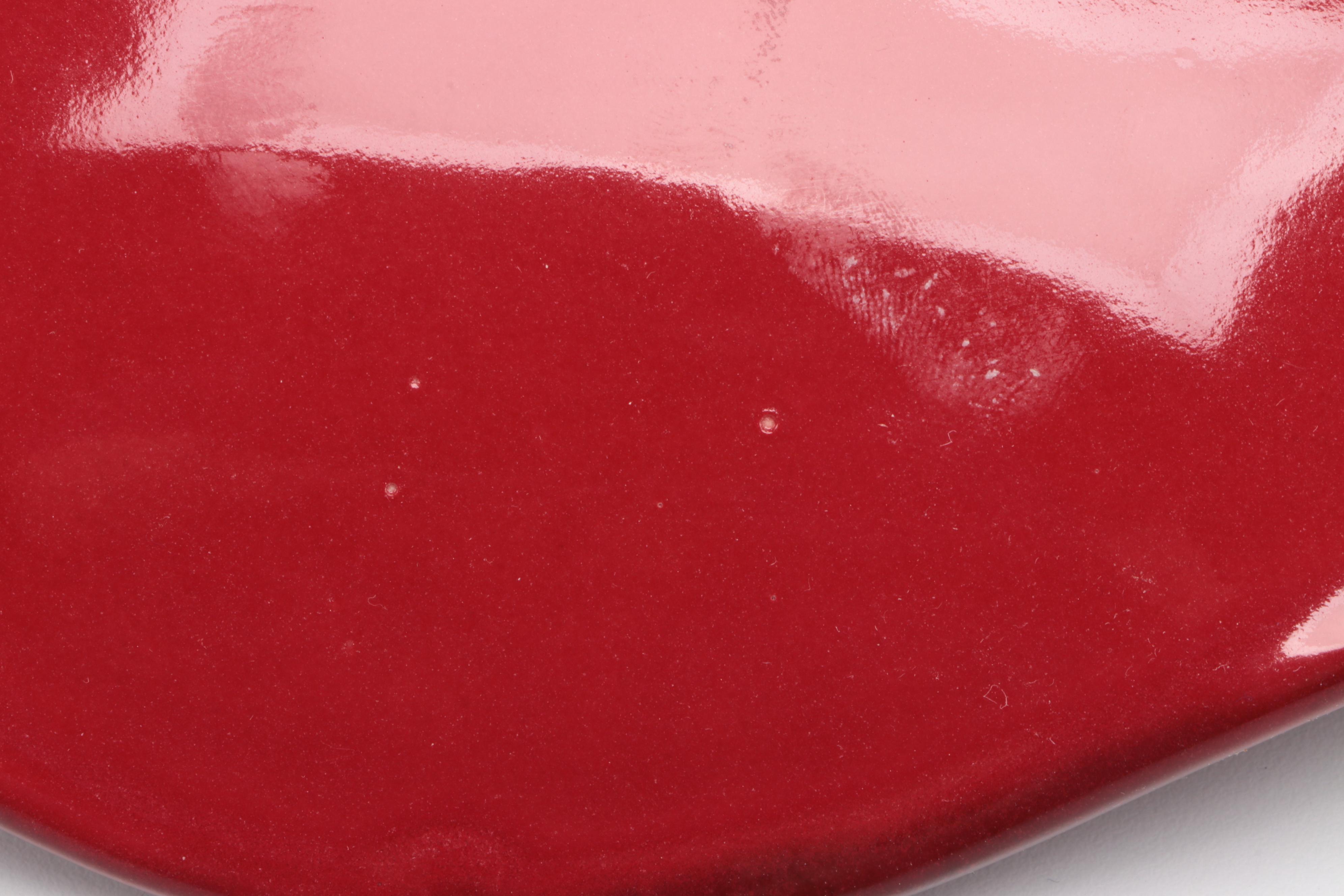 Red Glass Pitcher with Other Stoneware Dishes and Bowls