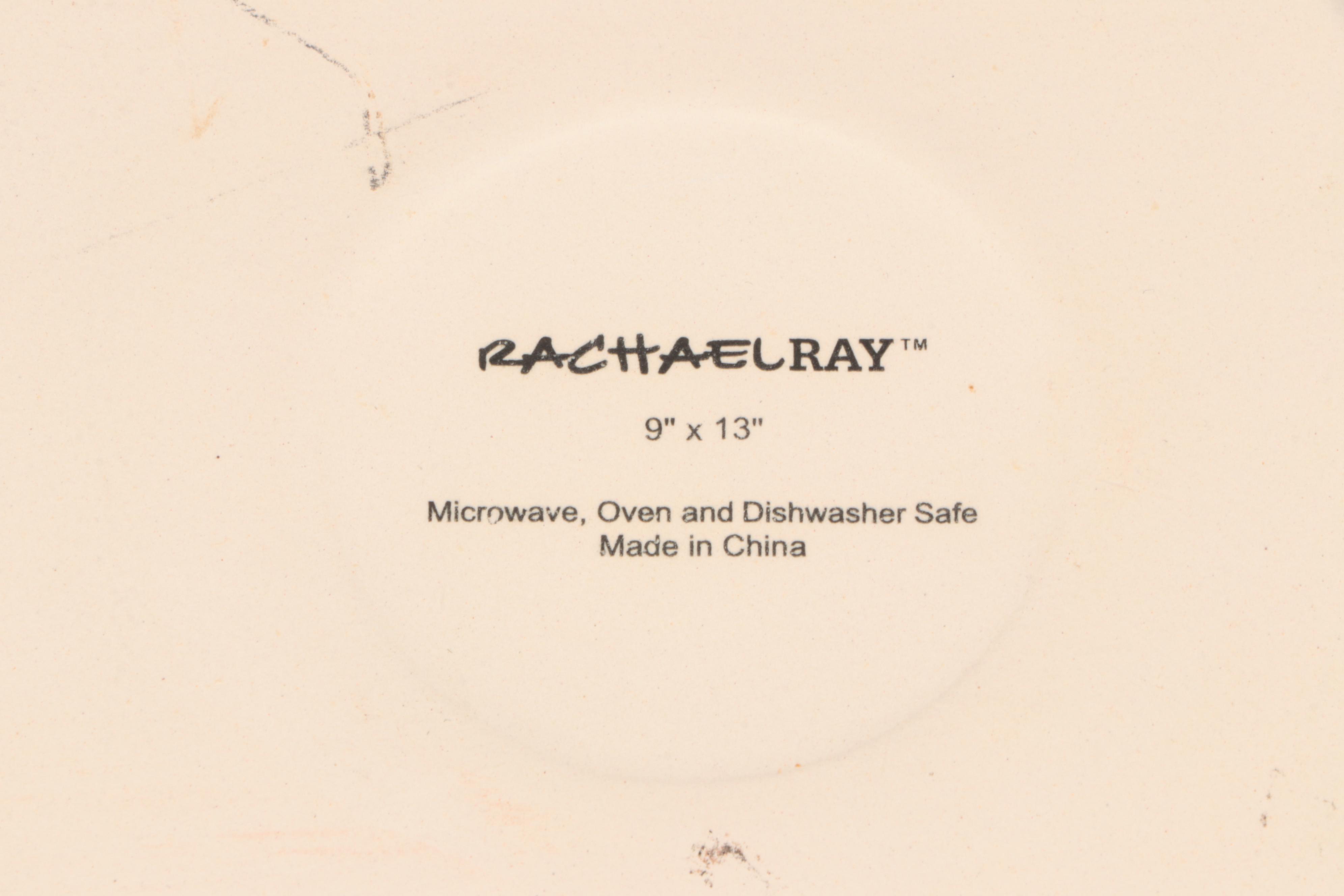 Red Glass Pitcher with Other Stoneware Dishes and Bowls