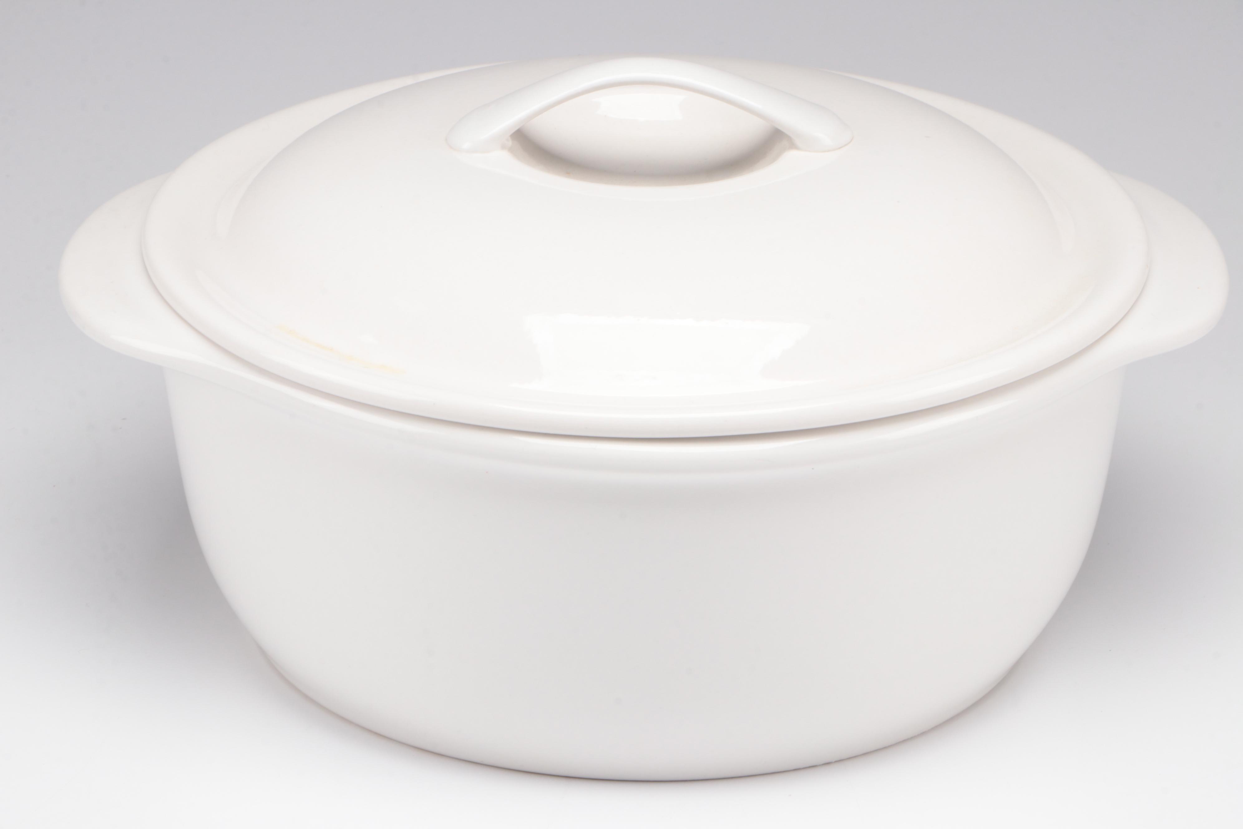 Red Glass Pitcher with Other Stoneware Dishes and Bowls