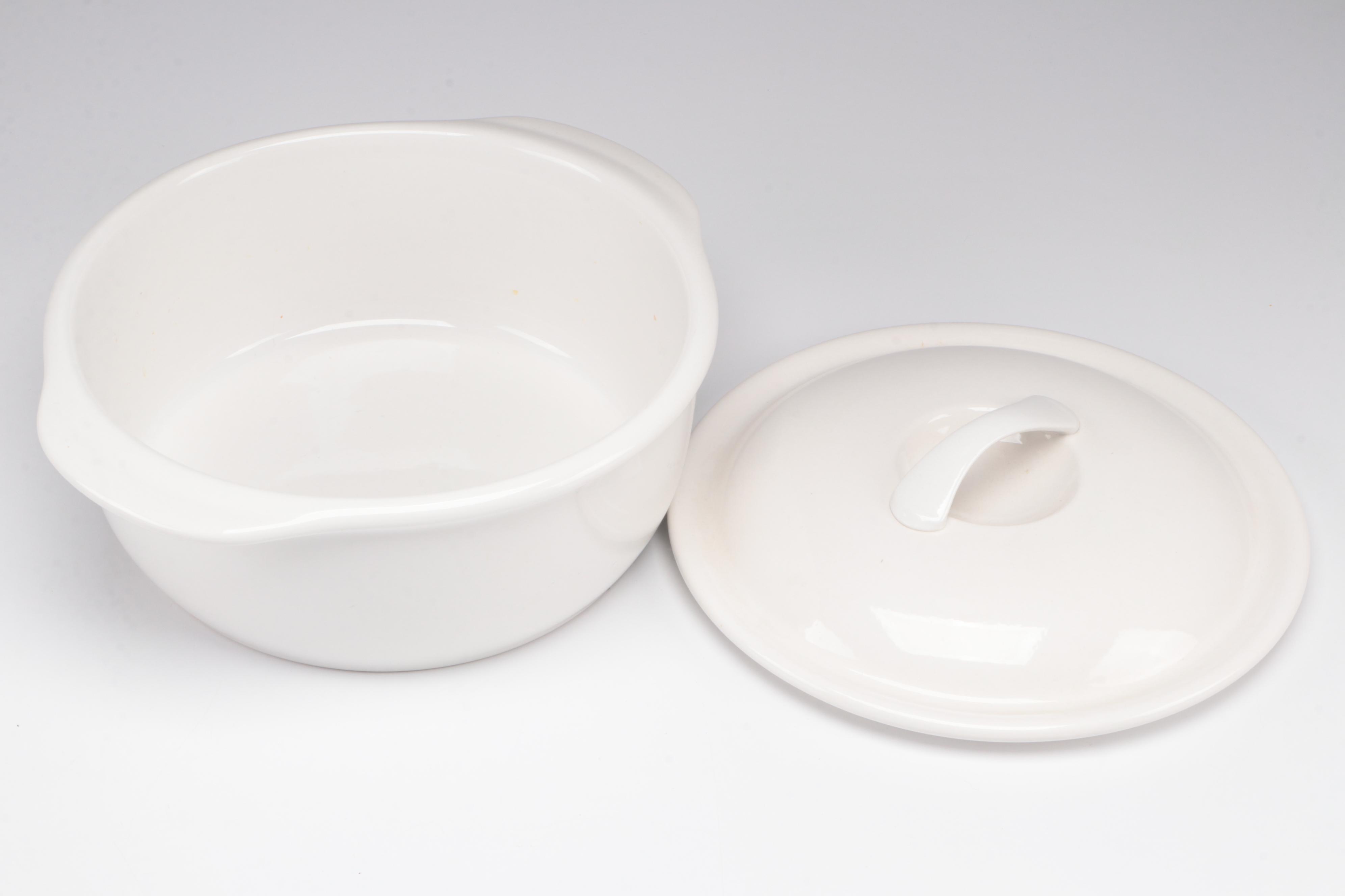 Red Glass Pitcher with Other Stoneware Dishes and Bowls