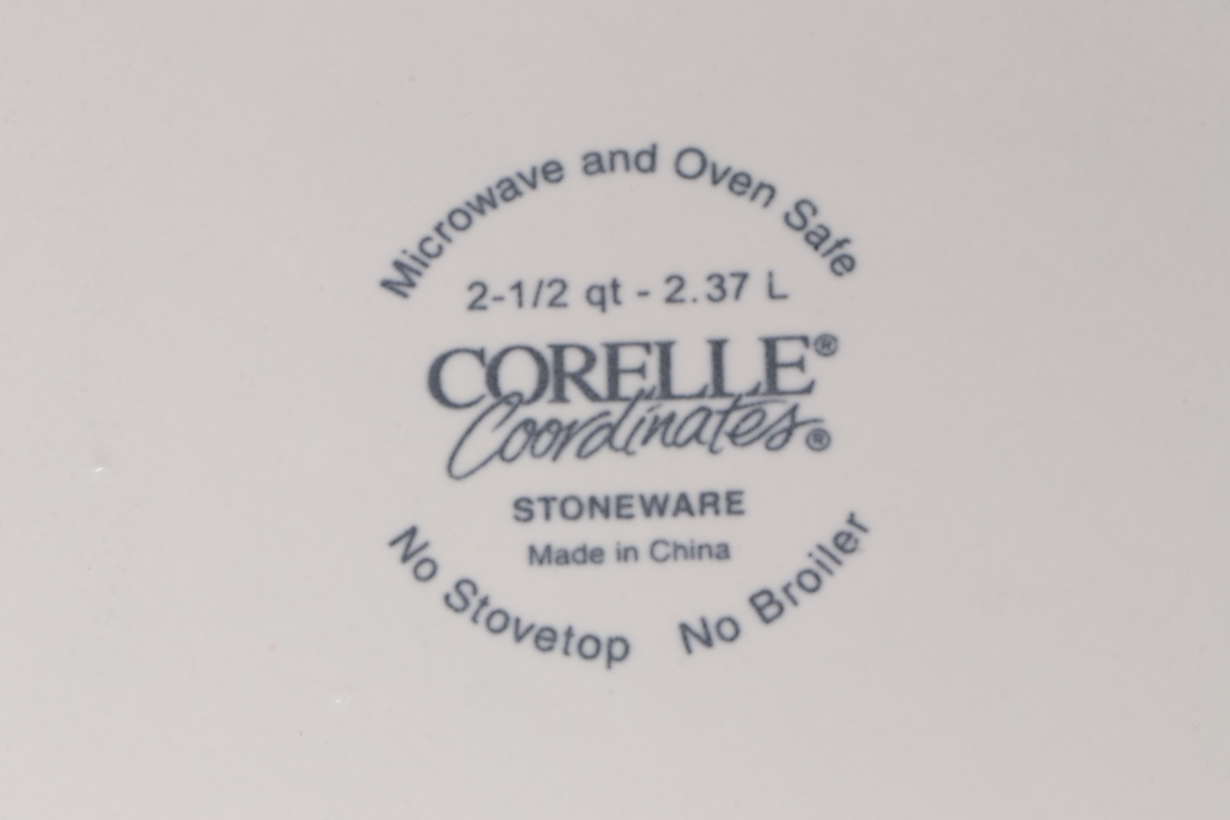 Red Glass Pitcher with Other Stoneware Dishes and Bowls