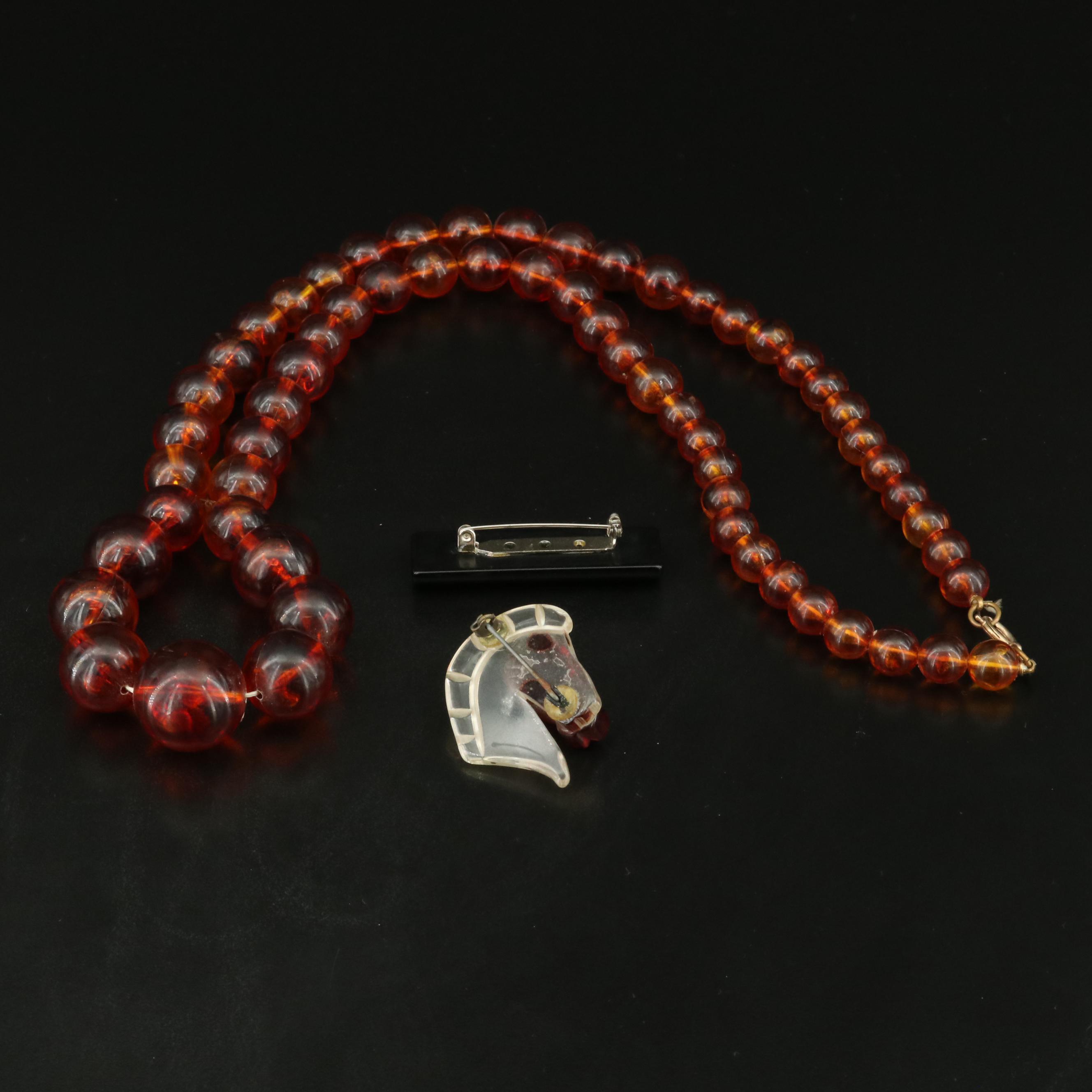 Graduated Plastic and Lucite Bead Necklace and Brooches