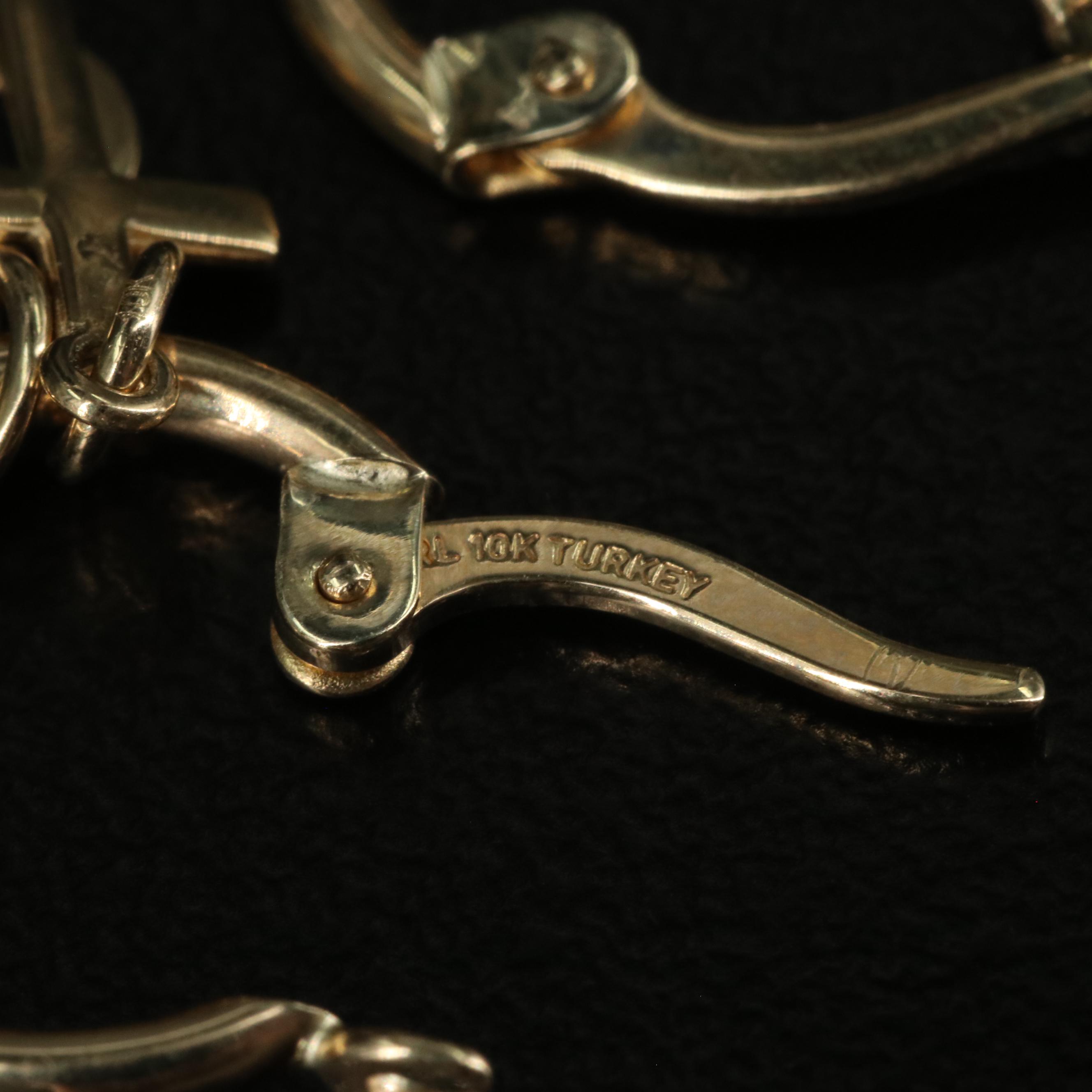 14K Huggie Hoop Earrings Featuring Dangling Hearts and Crosses