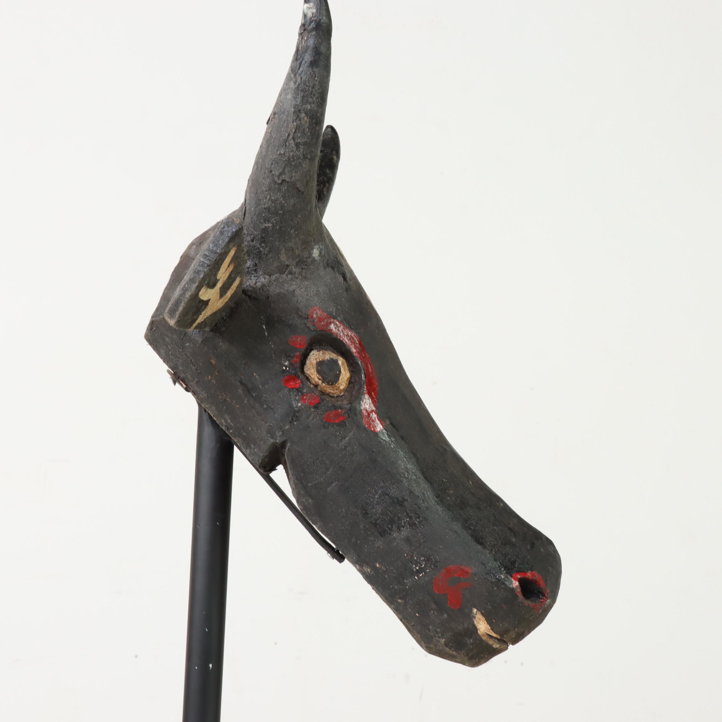 Carved and Polychrome-Decorated Nandi Head with Iron Stand