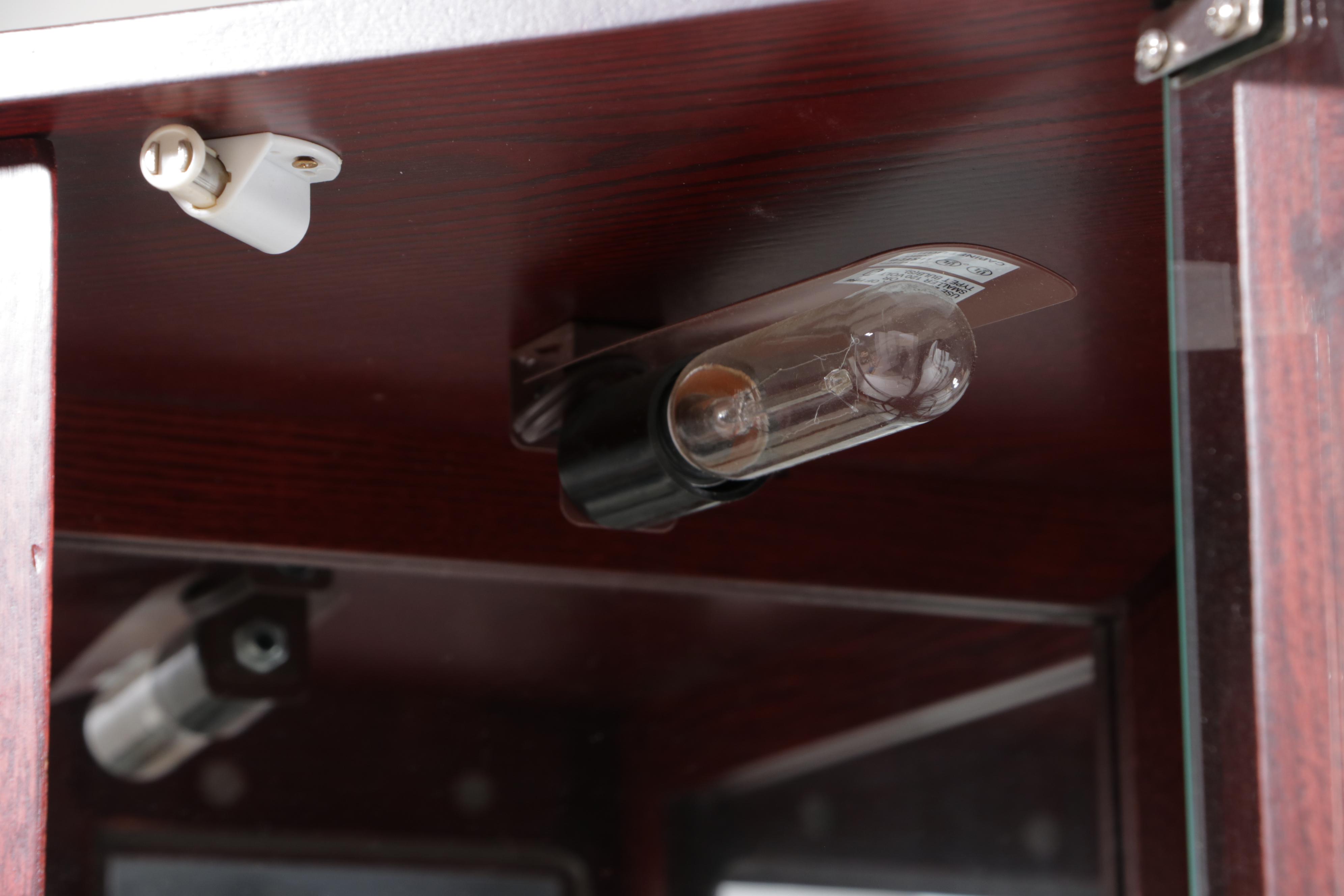 Pair of Mahogany Finish and Glass Illuminated Corner Display Cabinets