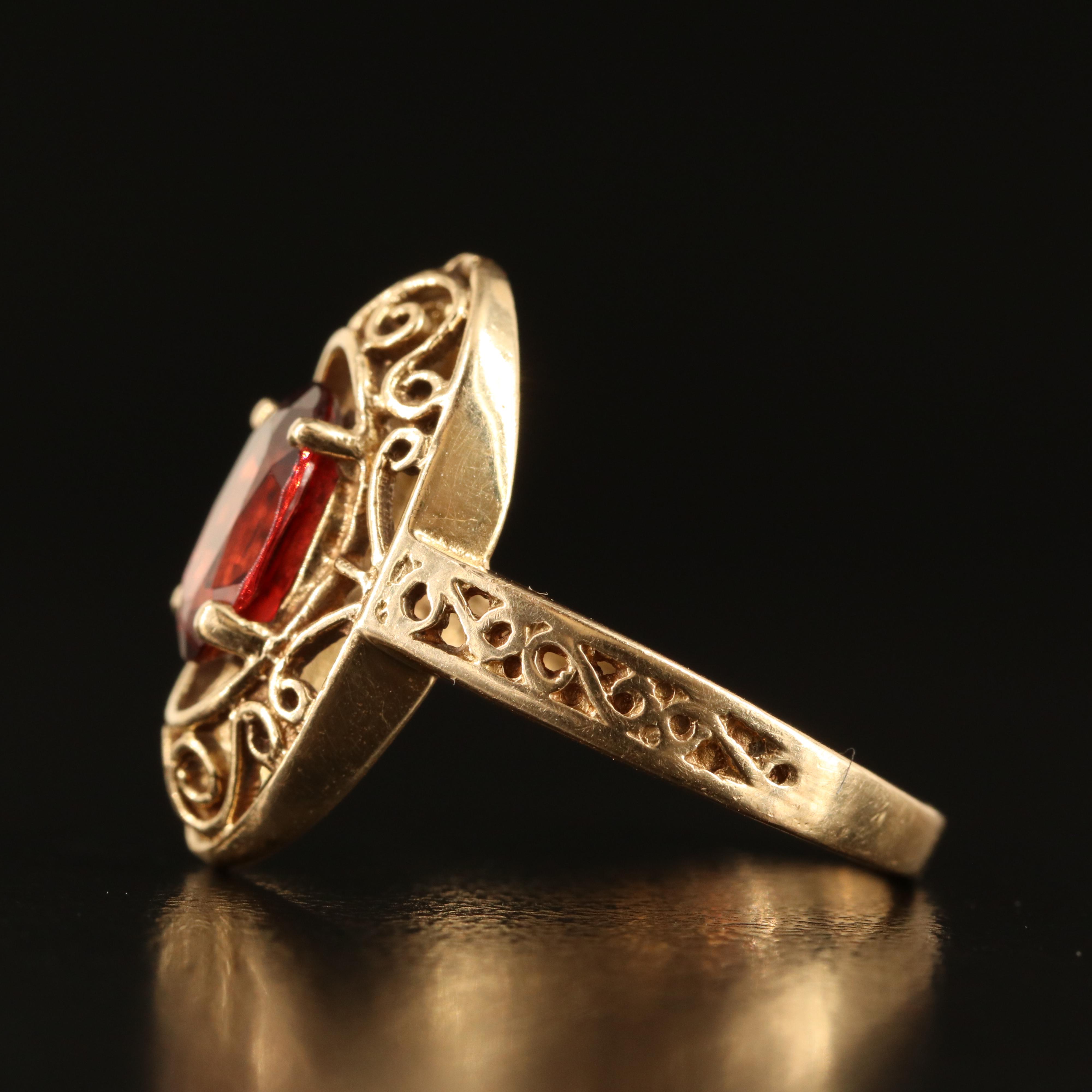 14K Garnet Oval Ring with Scroll Detail
