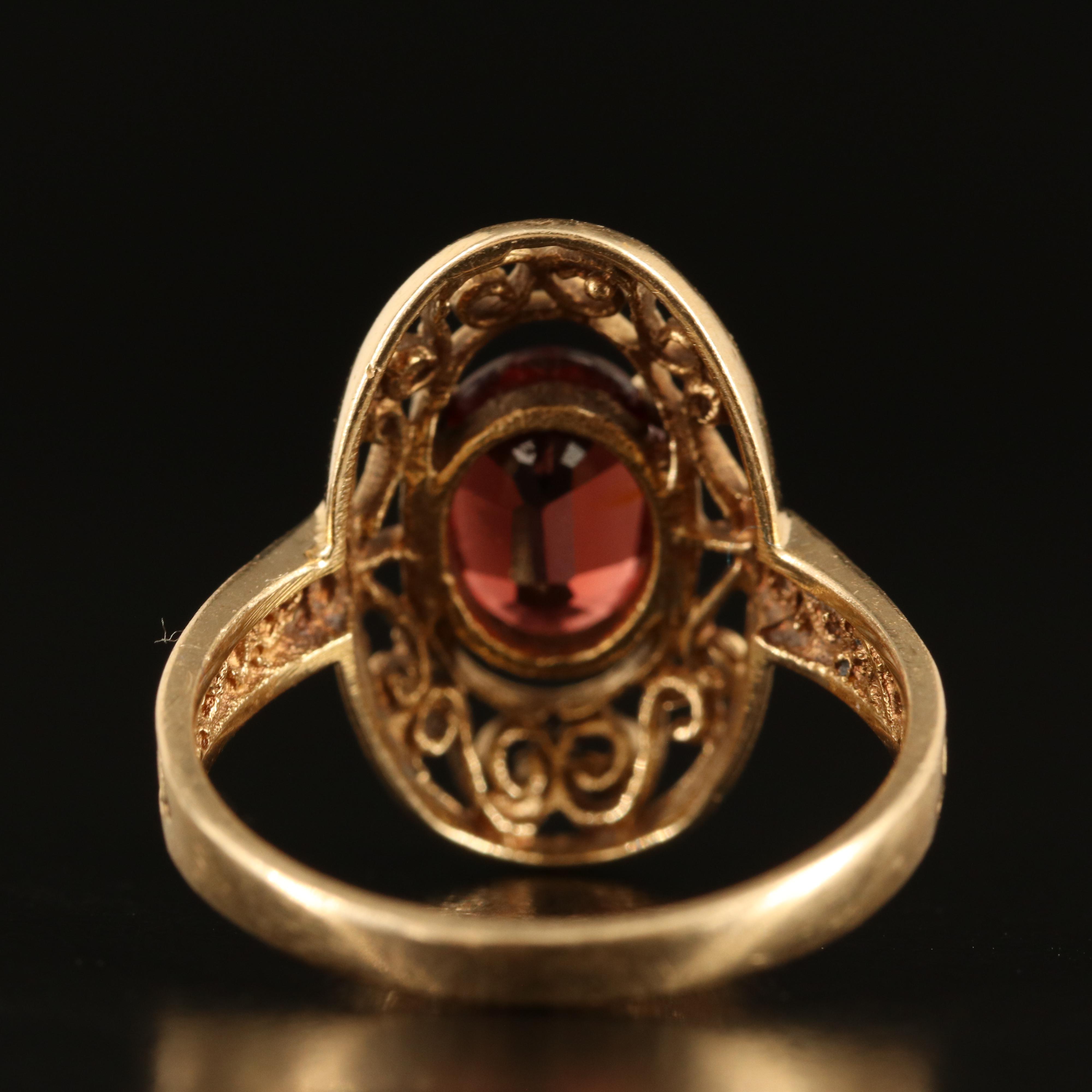 14K Garnet Oval Ring with Scroll Detail