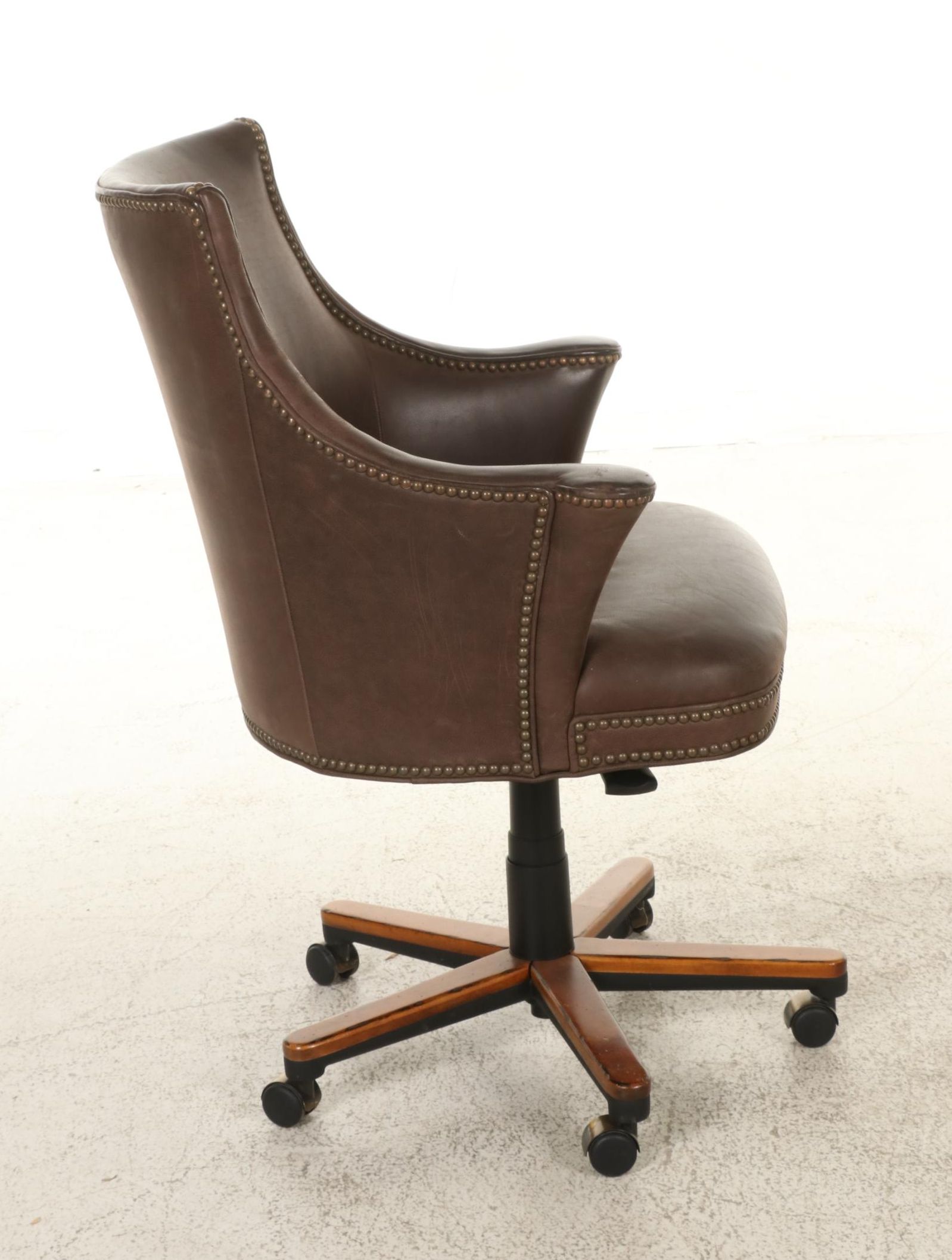 Pair of Brass-Tacked and Aged Leather Upholstered Adjustable Swivel Chairs