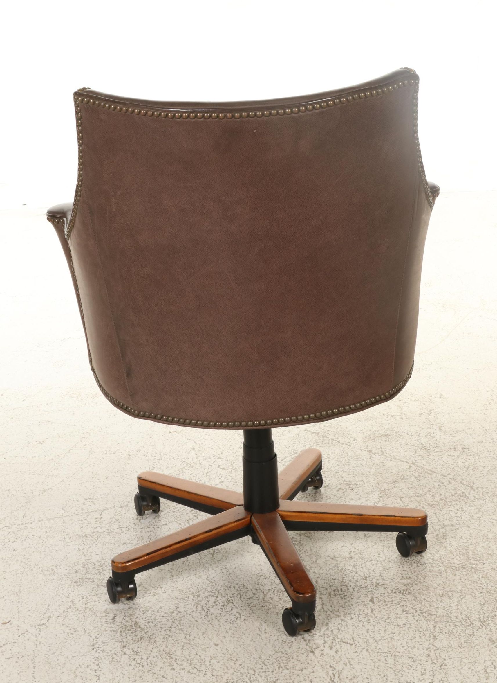 Pair of Brass-Tacked and Aged Leather Upholstered Adjustable Swivel Chairs