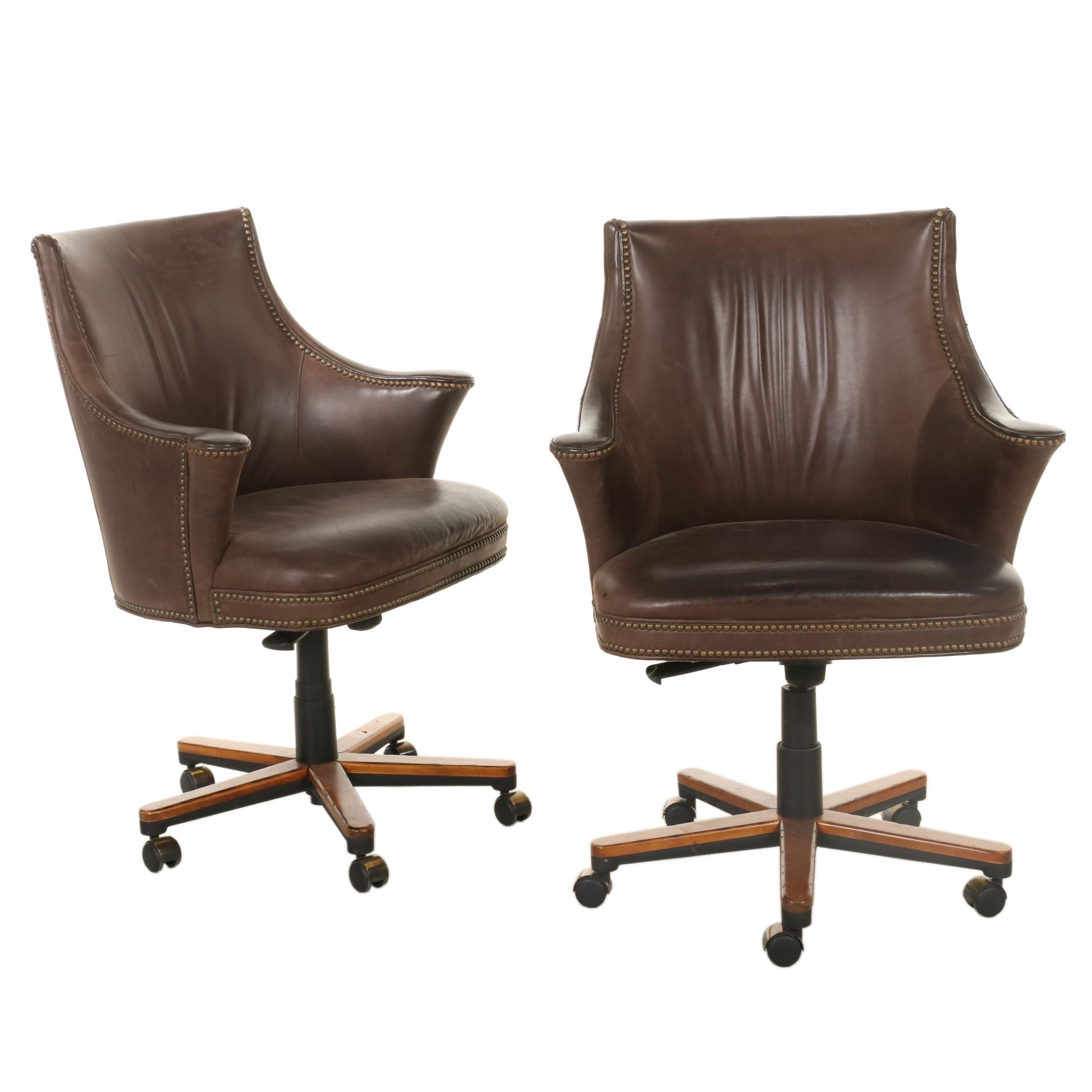 Pair of Brass-Tacked and Aged Leather Upholstered Adjustable Swivel Chairs