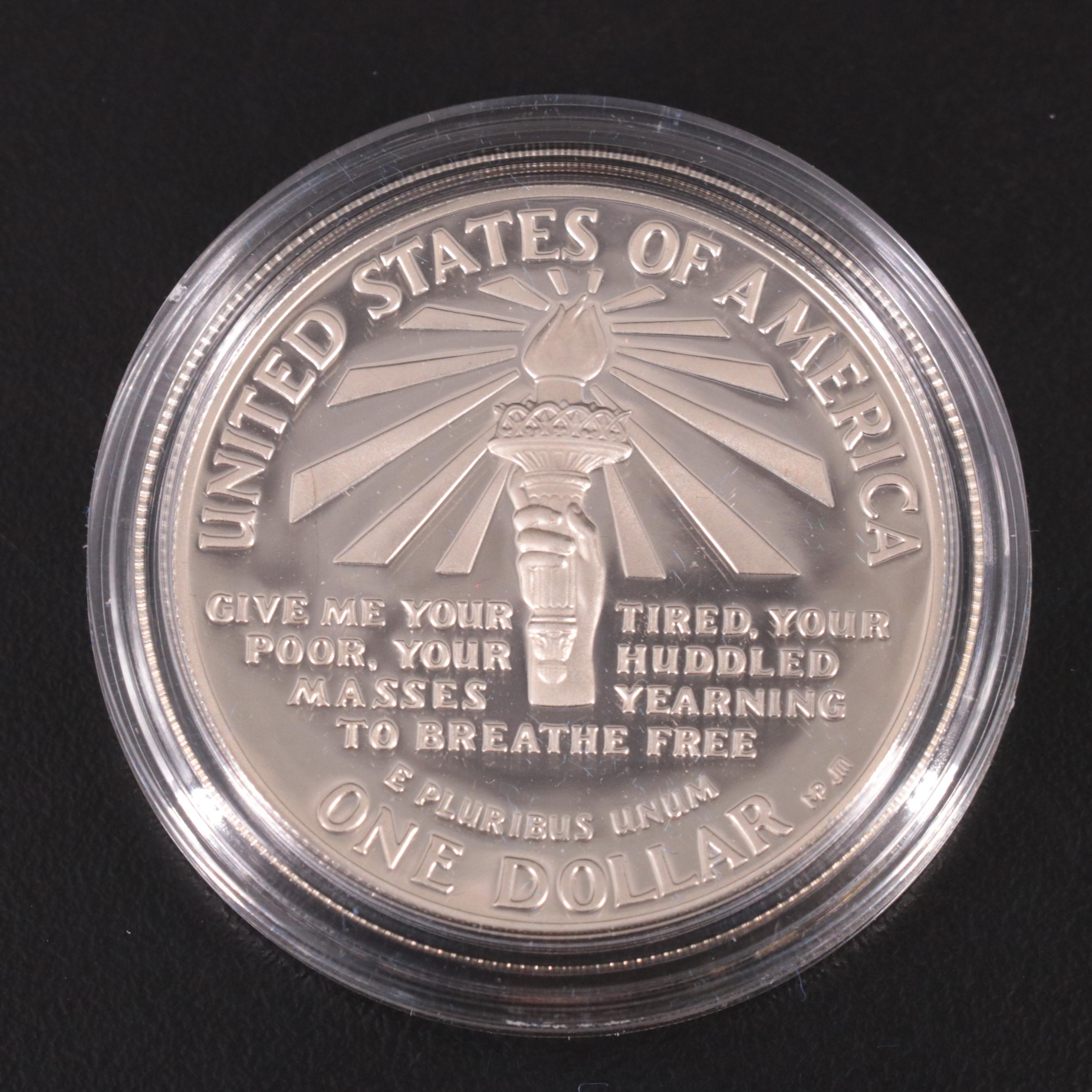 Two Statue of Liberty Commemorative Coin Sets and an Eisenhower Silver Dollar