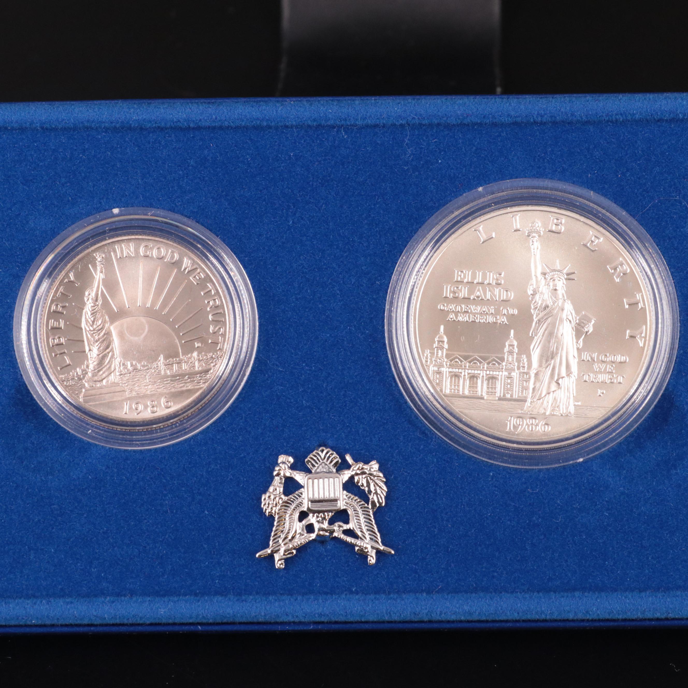 Two Statue of Liberty Commemorative Coin Sets and an Eisenhower Silver Dollar