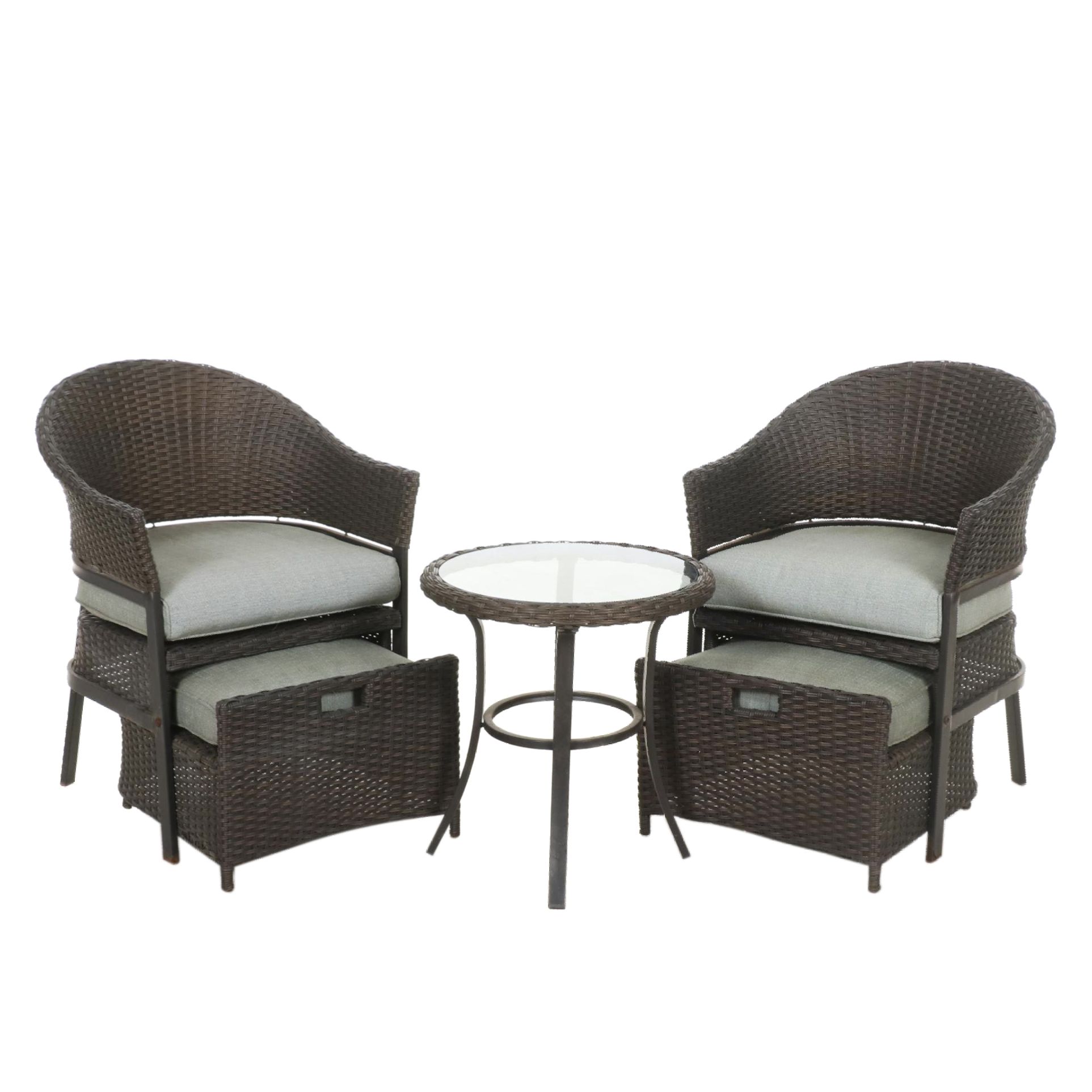 Two Contemporary Resin Wicker Patio Chairs and Ottomans With Accent Table