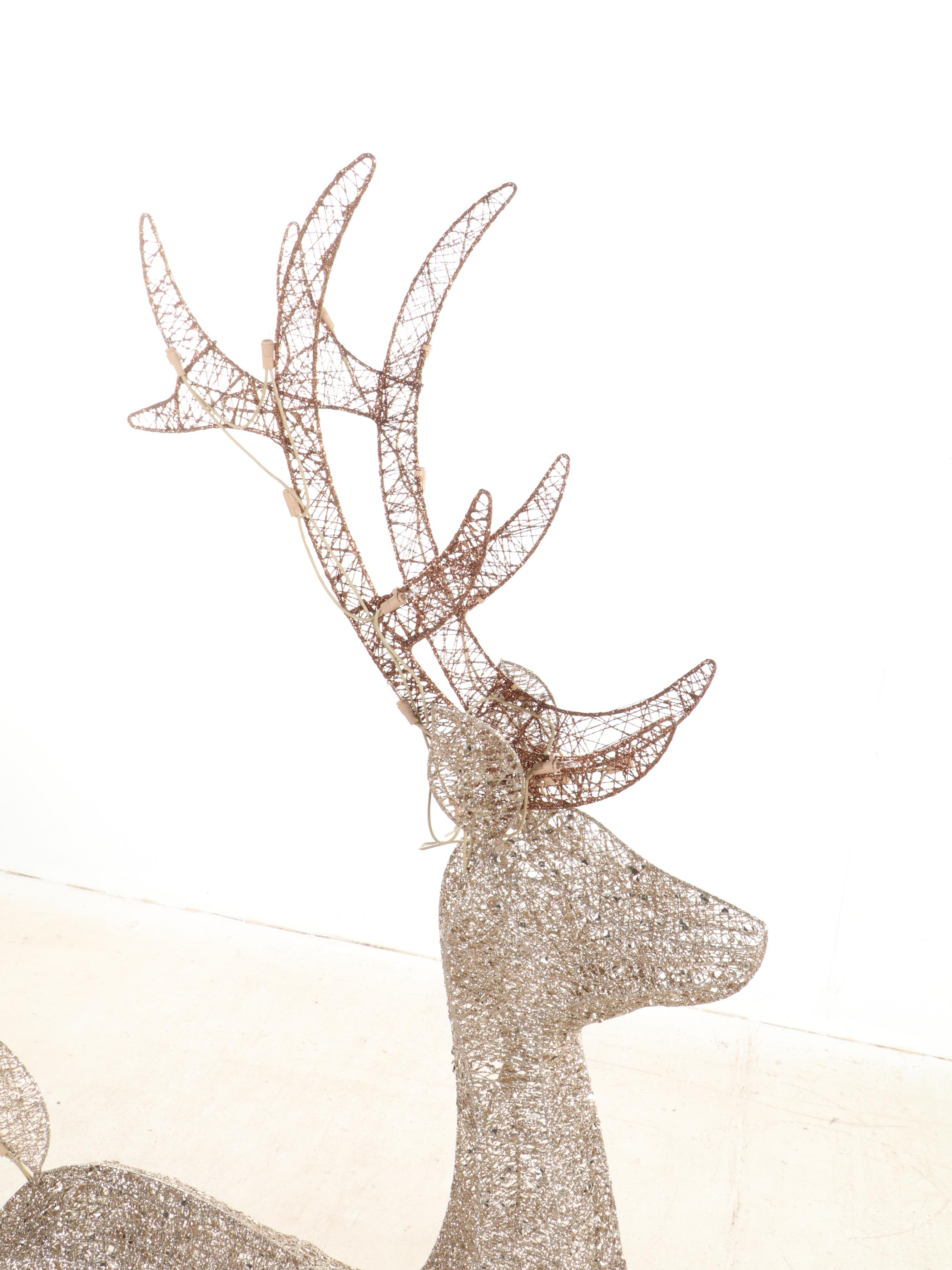 Glittering Illuminated Grapevine Reindeer Figures With Faux Evergreen Garland