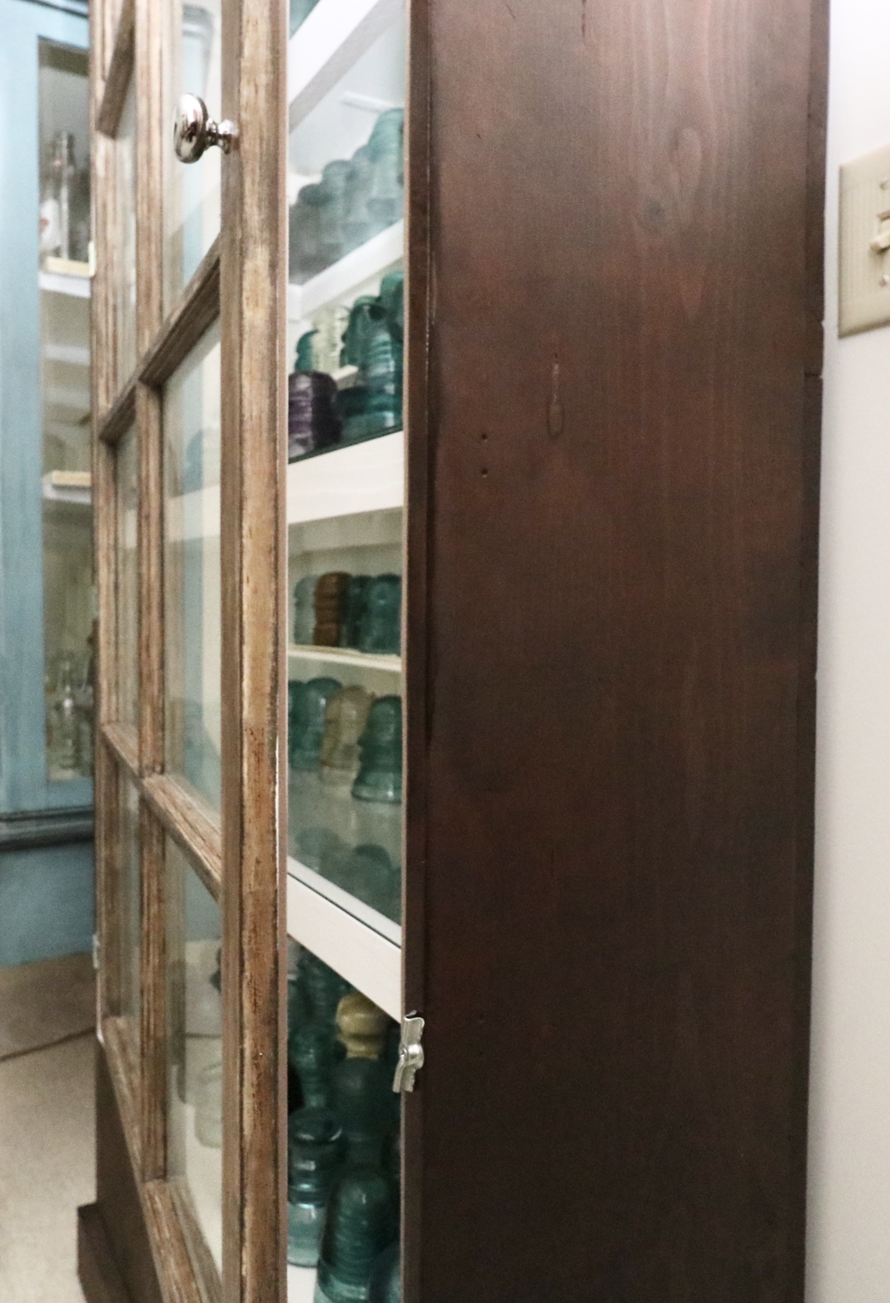 Handcrafted Curio Cabinet Featuring an Insulator Collection