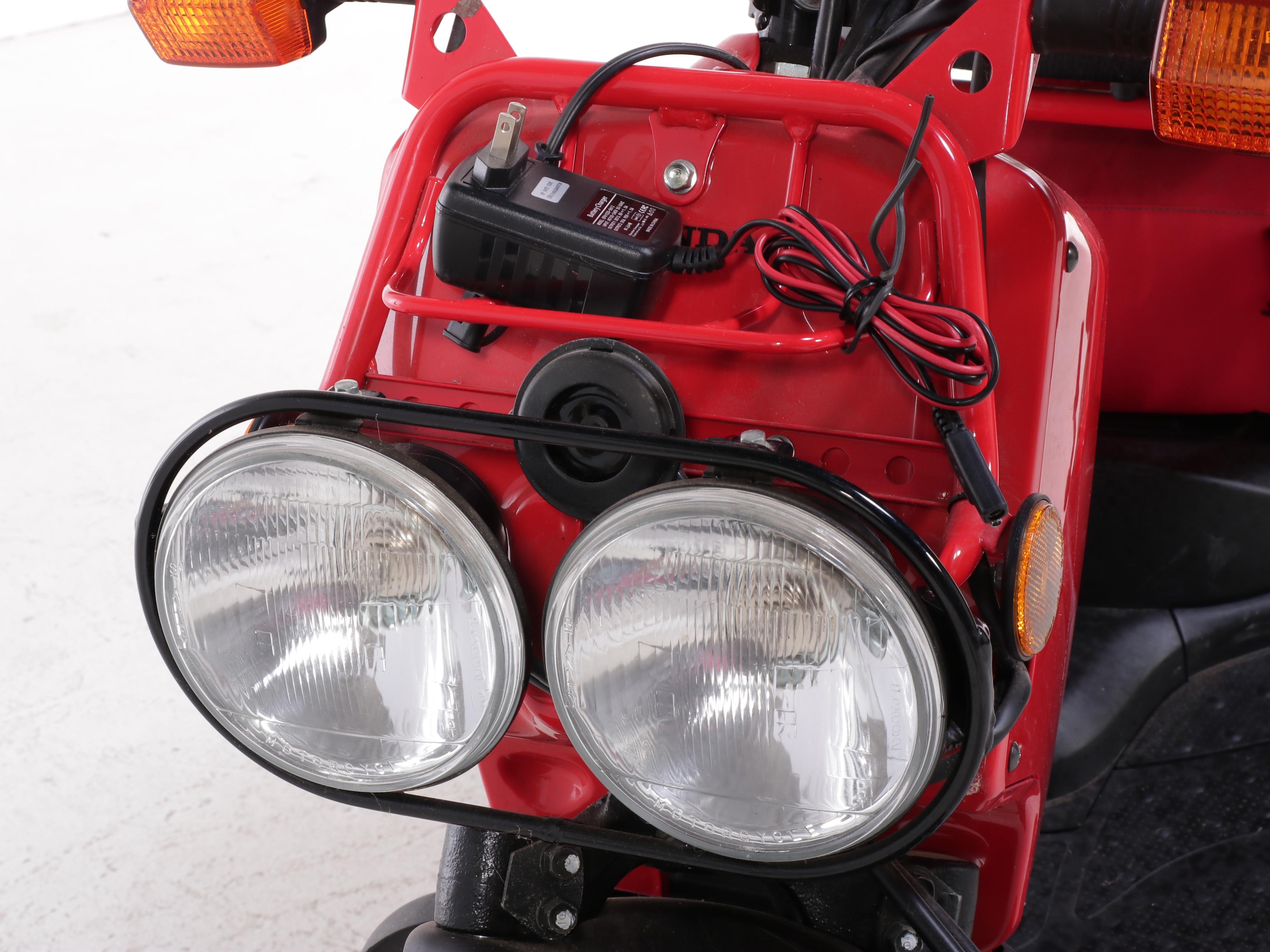 2009 Honda Ruckus Scooter in Red with with HJC Half-Shell Helmets