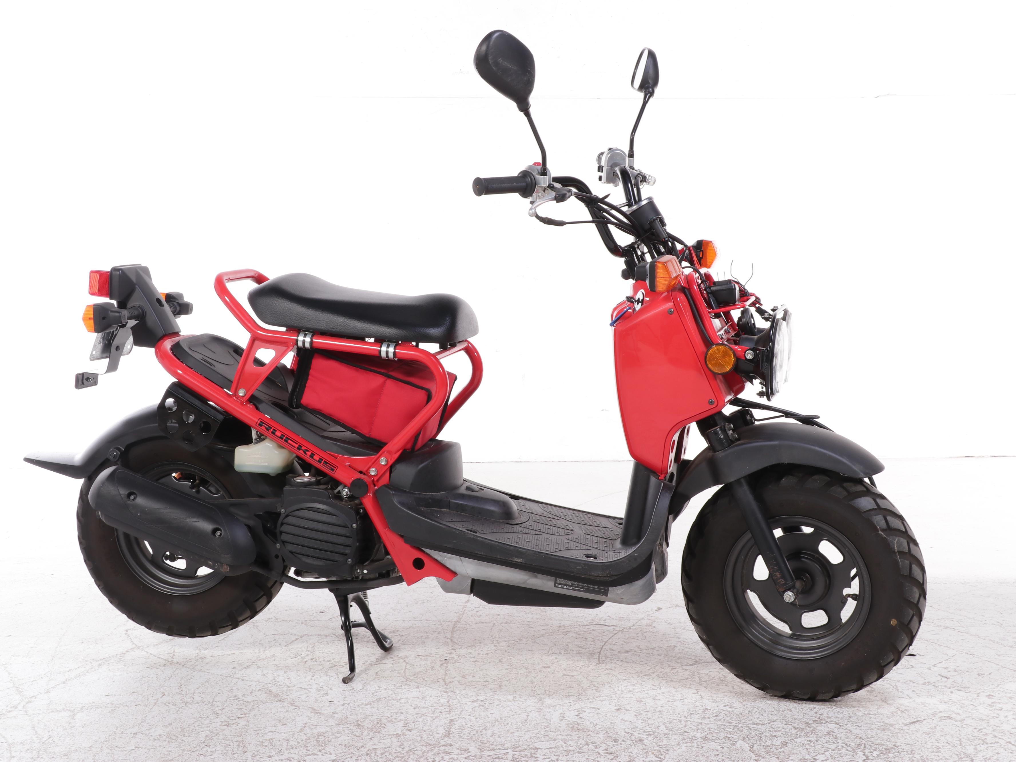 2009 Honda Ruckus Scooter in Red with with HJC Half-Shell Helmets