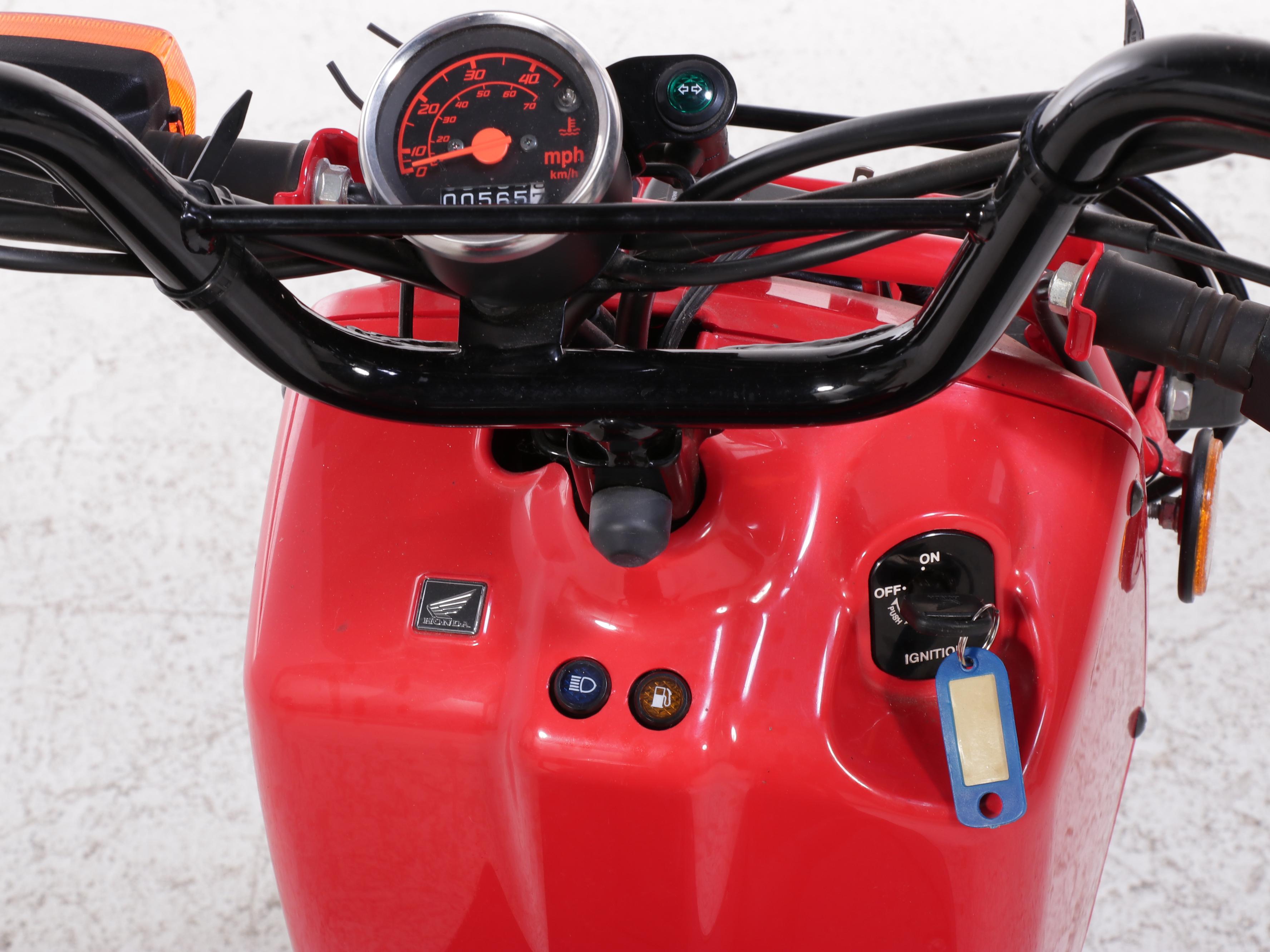 2009 Honda Ruckus Scooter in Red with with HJC Half-Shell Helmets