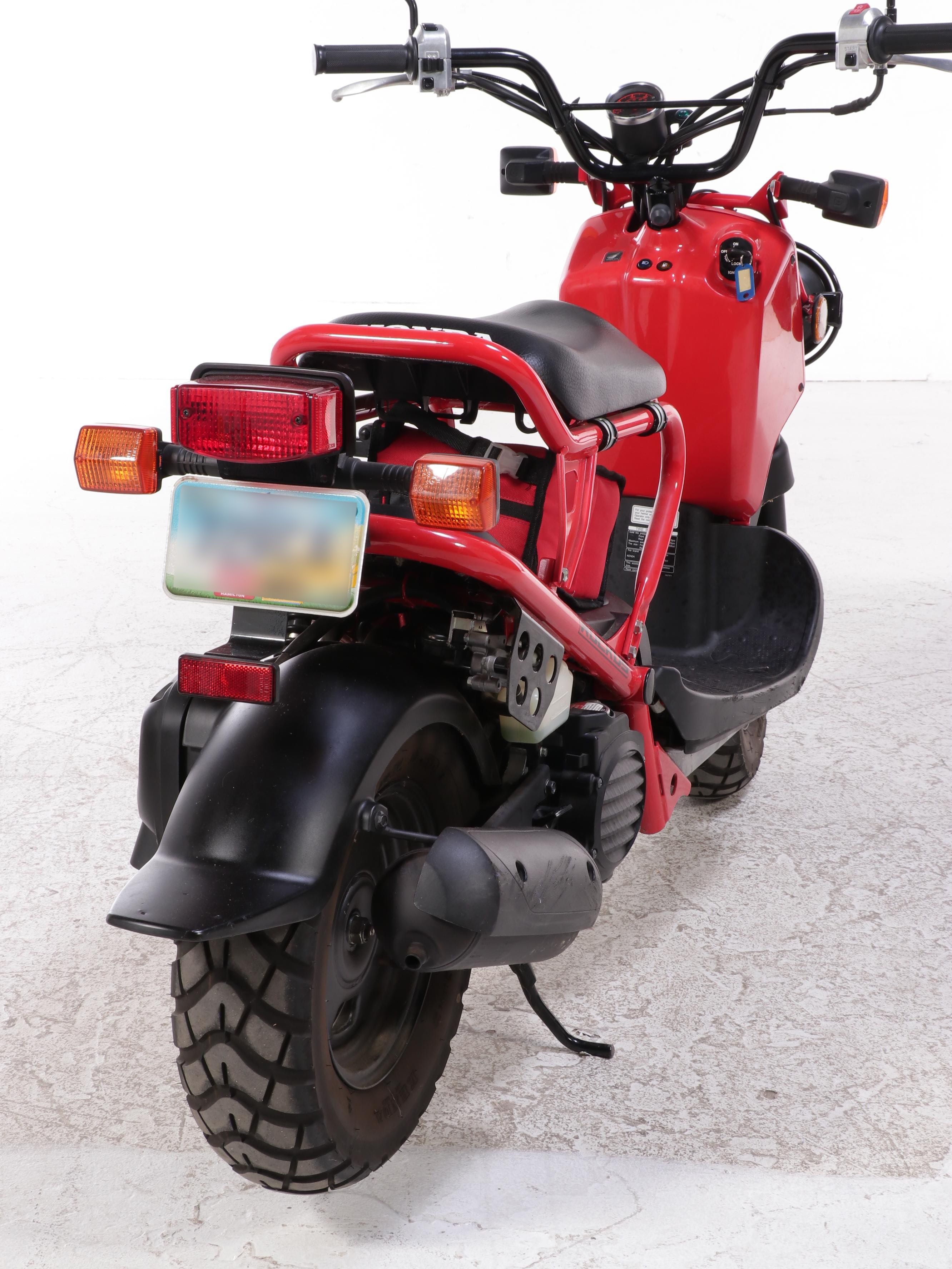 2009 Honda Ruckus Scooter in Red with with HJC Half-Shell Helmets