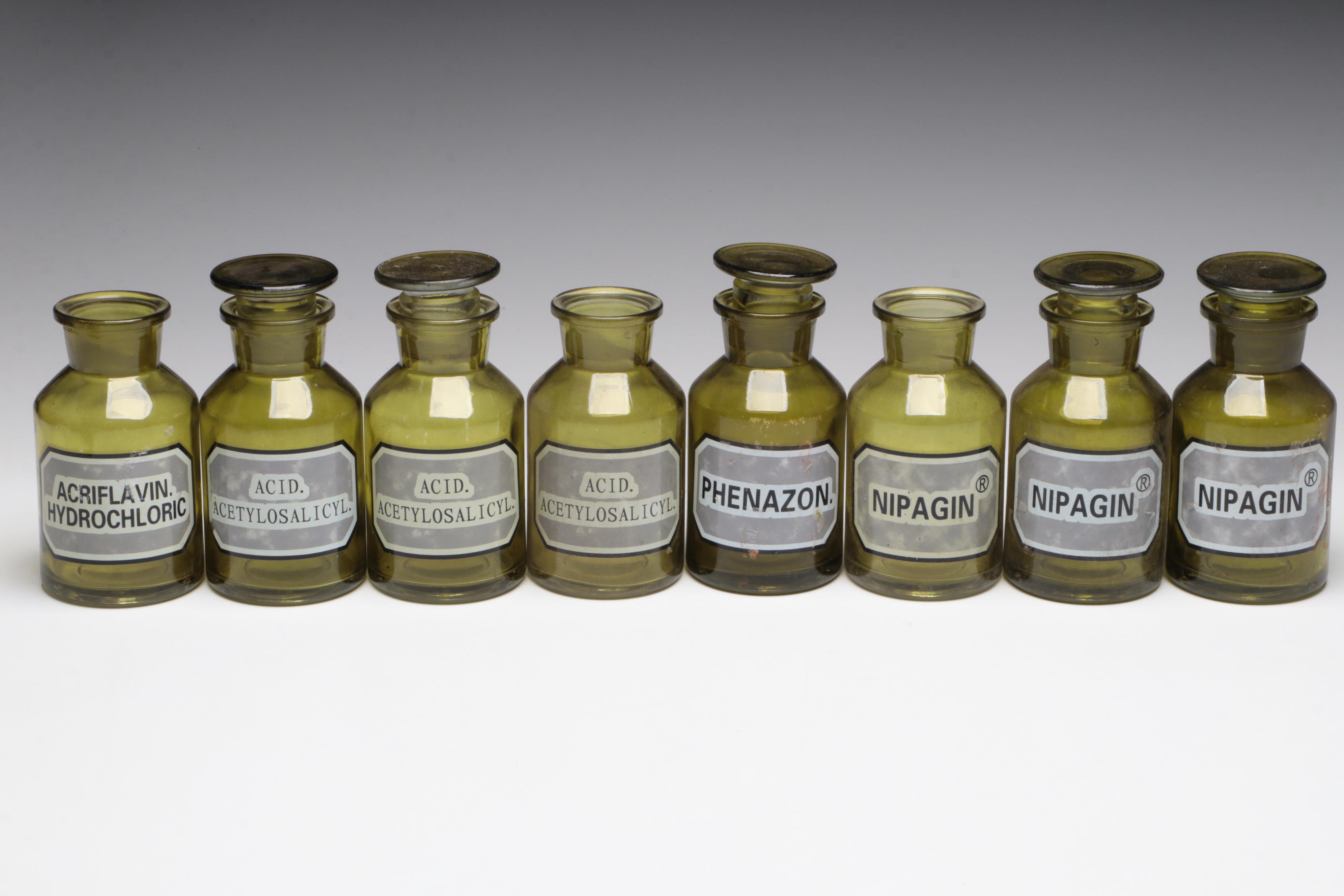 Olive and Clear Glass Apothecary Bottles With Drawer and Glass Bowl