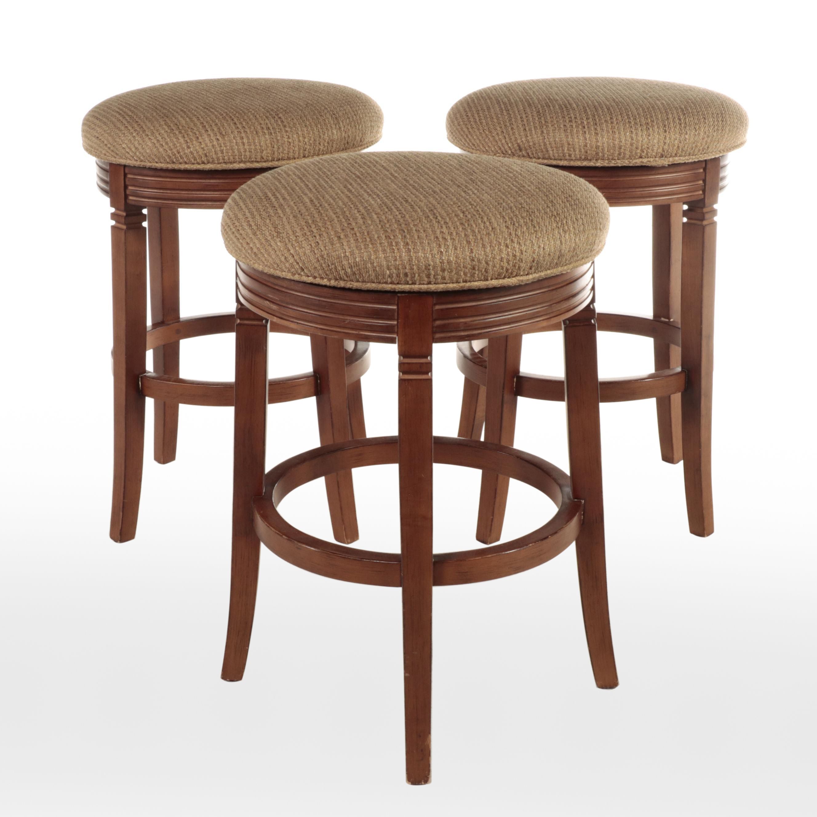 Three CherrywoodStained and CustomUpholstered Swivel Bar Stools EBTH