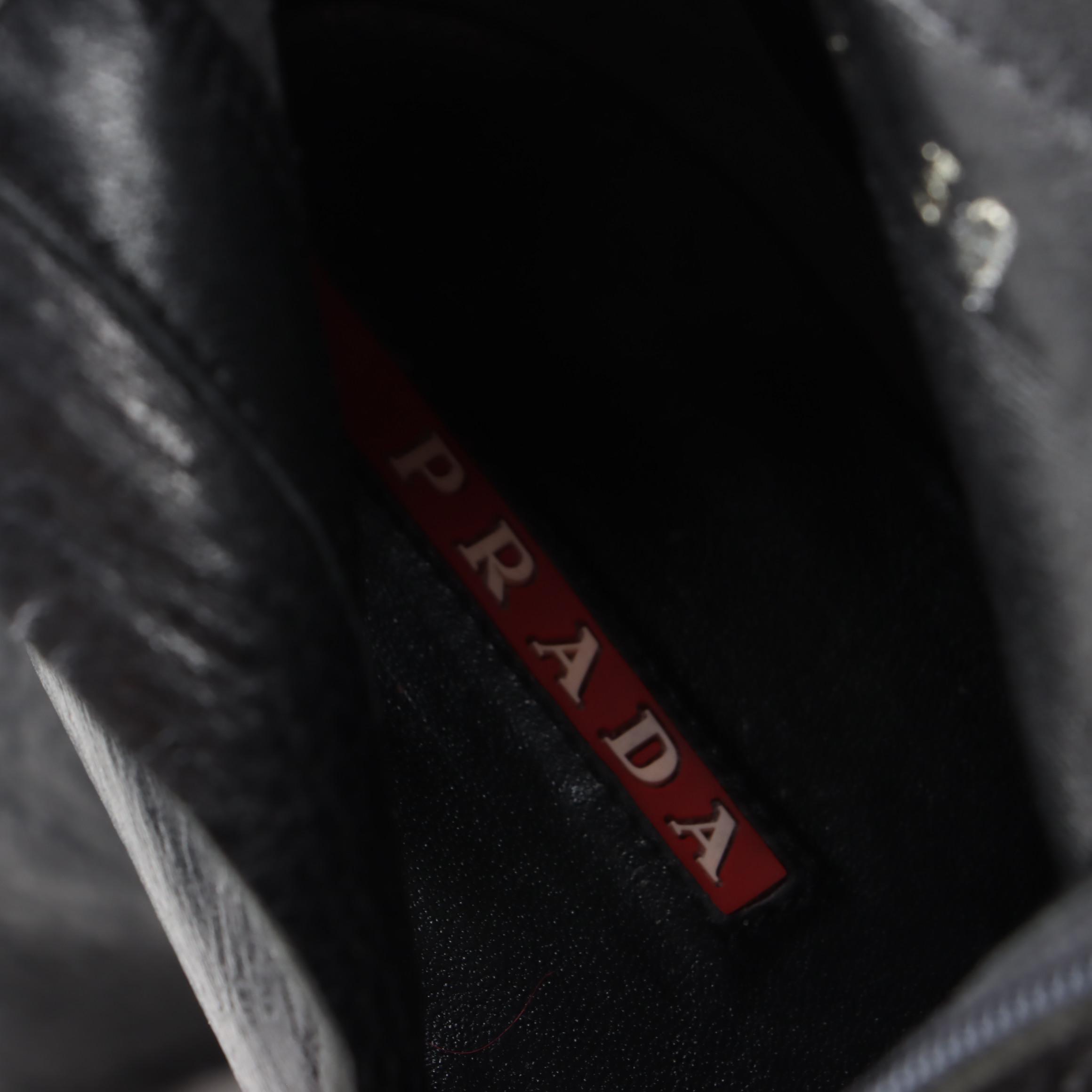 Prada Knee-High Heeled Boots in Black Grained Leather