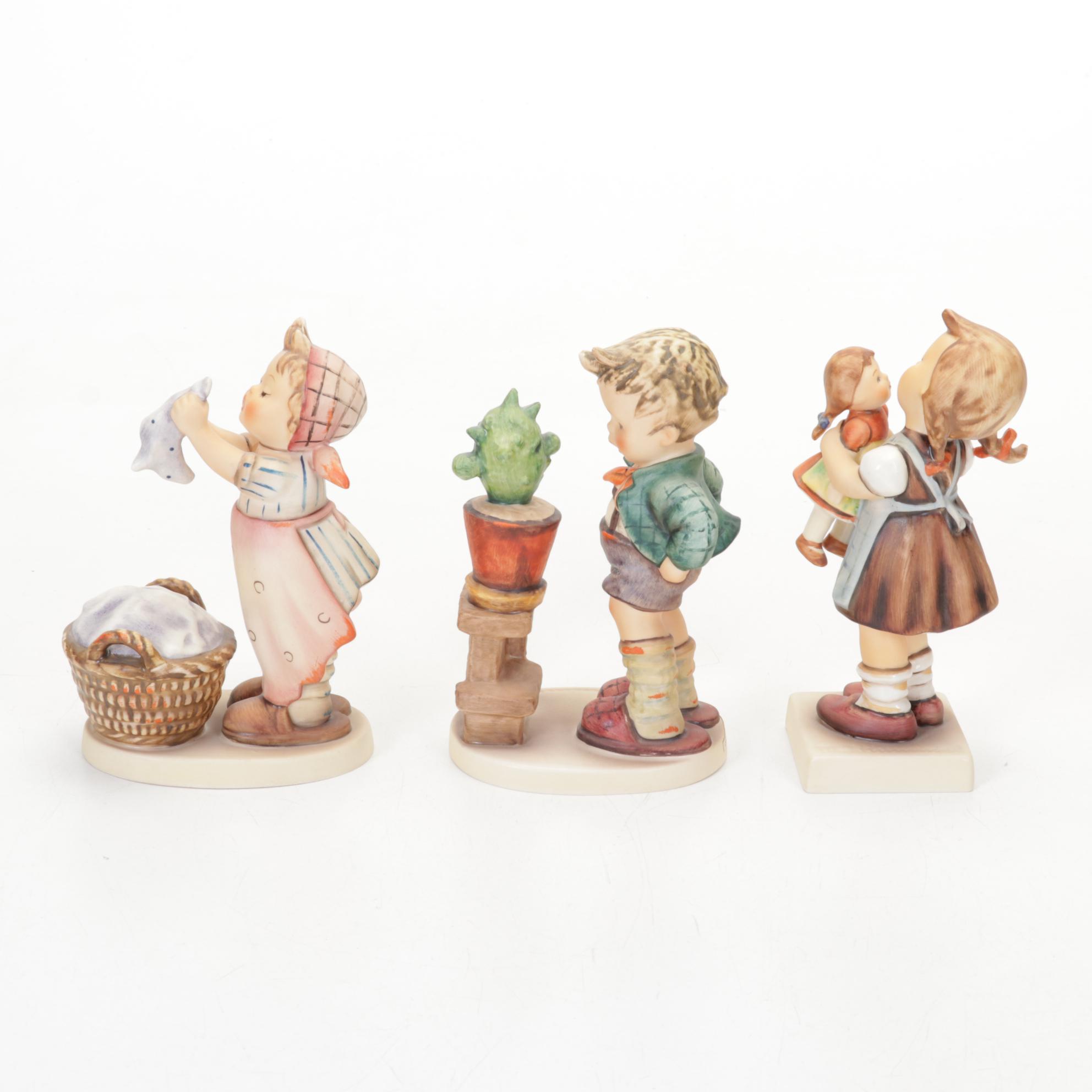 Goebel Hummel Porcelain Figurines Featuring Authorized Dealer Advertising Plaque