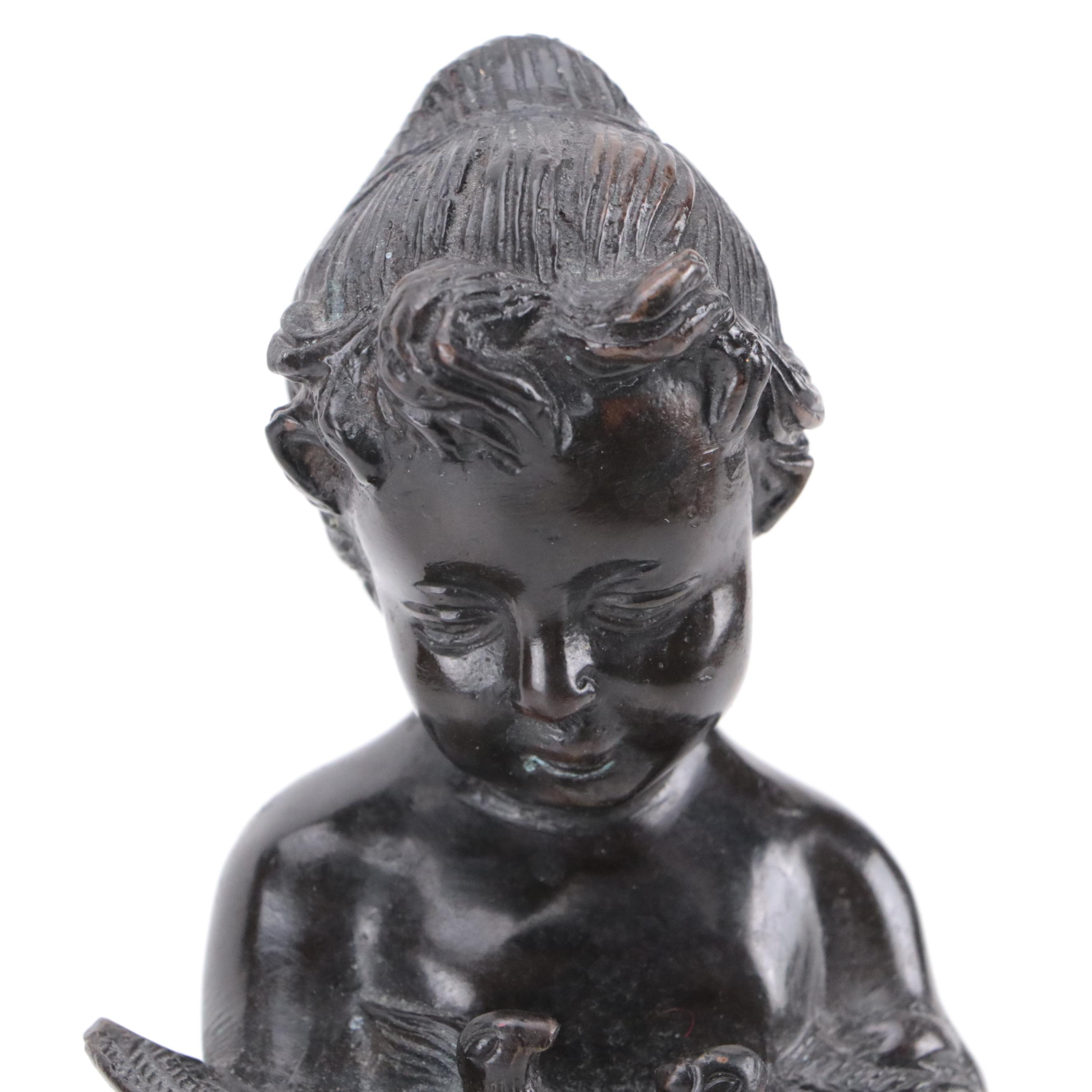 Bronze Sculpture of a Child Holding Birds
