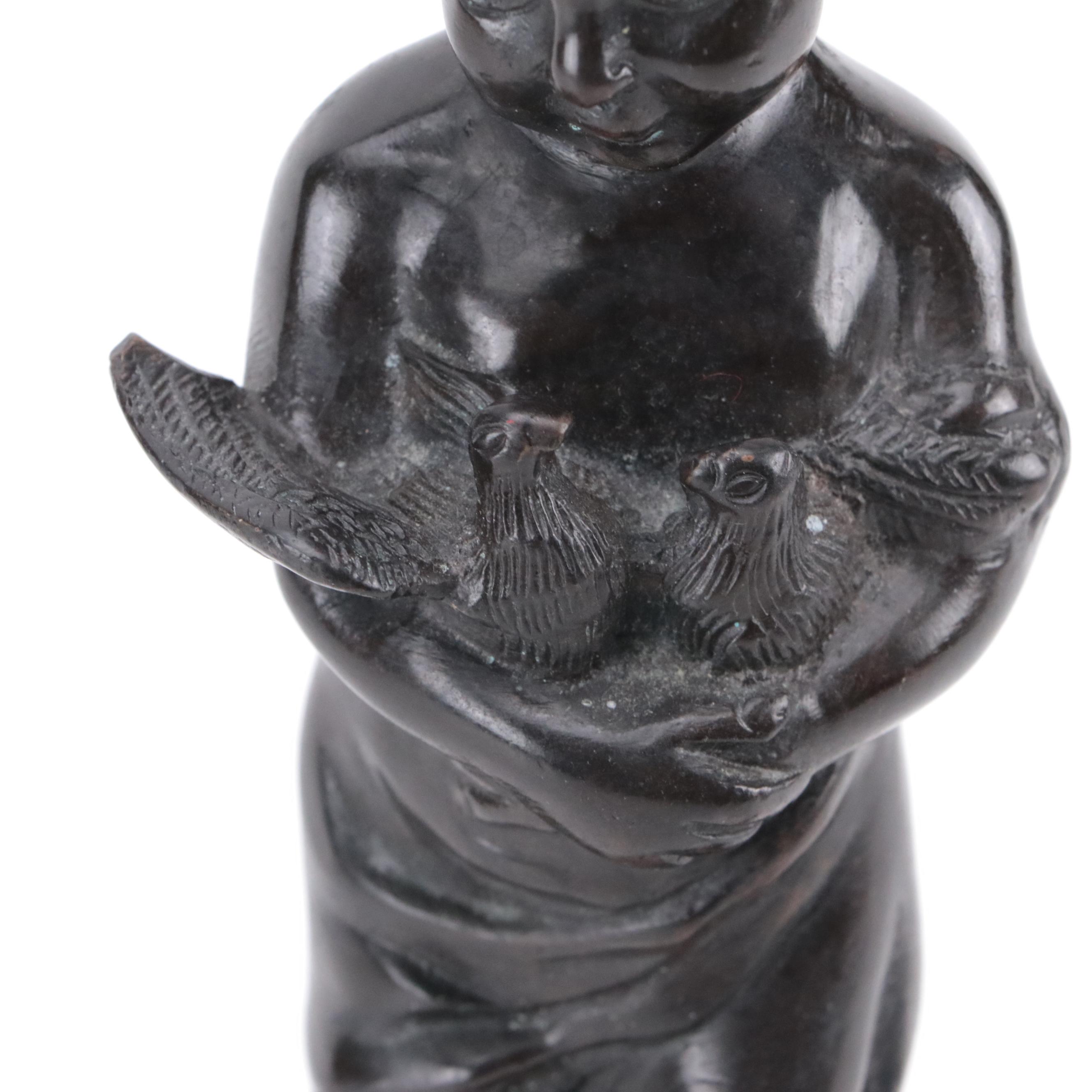 Bronze Sculpture of a Child Holding Birds