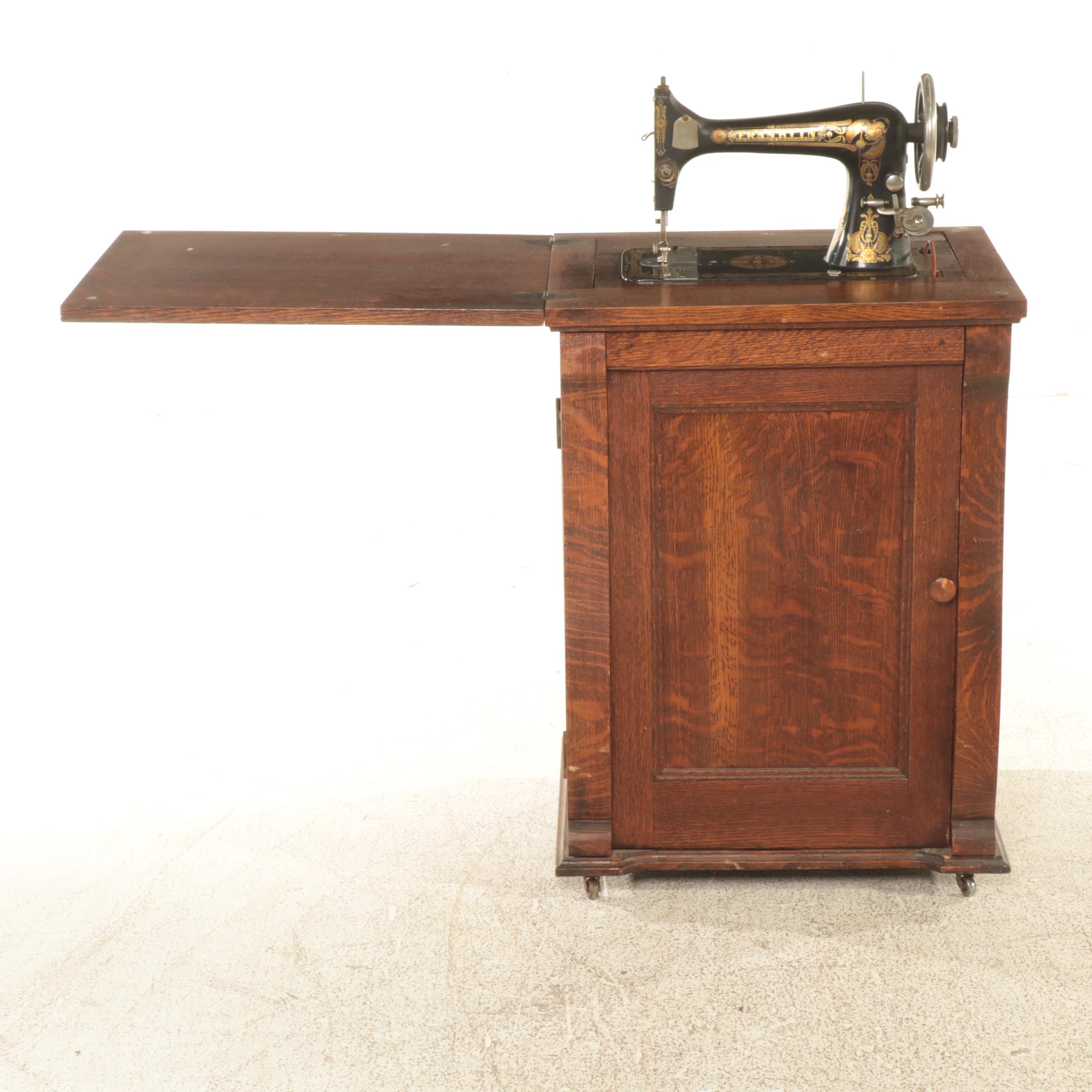 Franklin Egyptian Revival Decorated Treadle Sewing Machine in Oak Cabinet