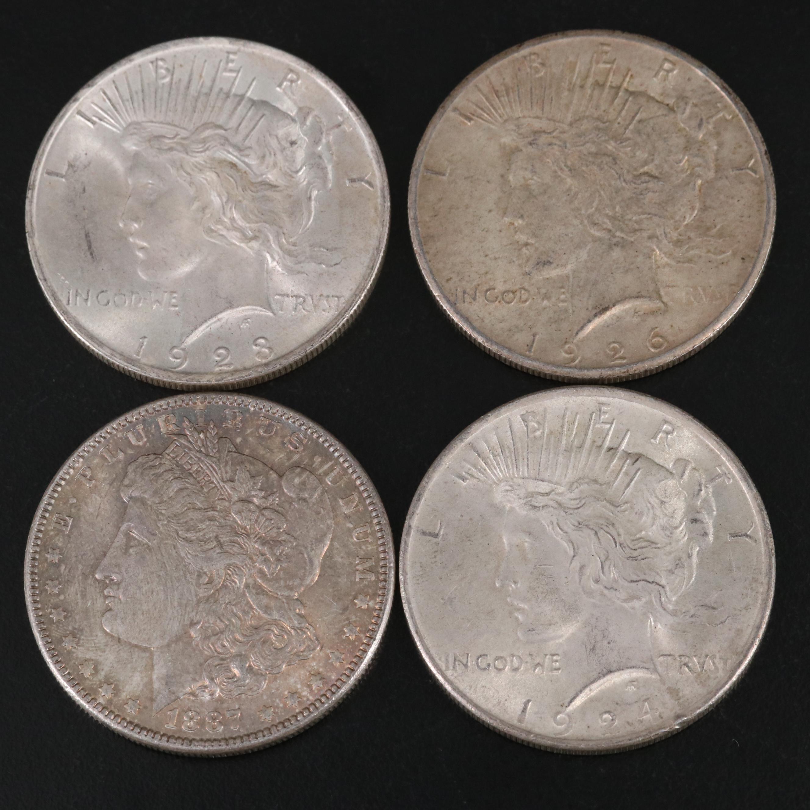 Nineteen Morgan and Peace Silver Dollars