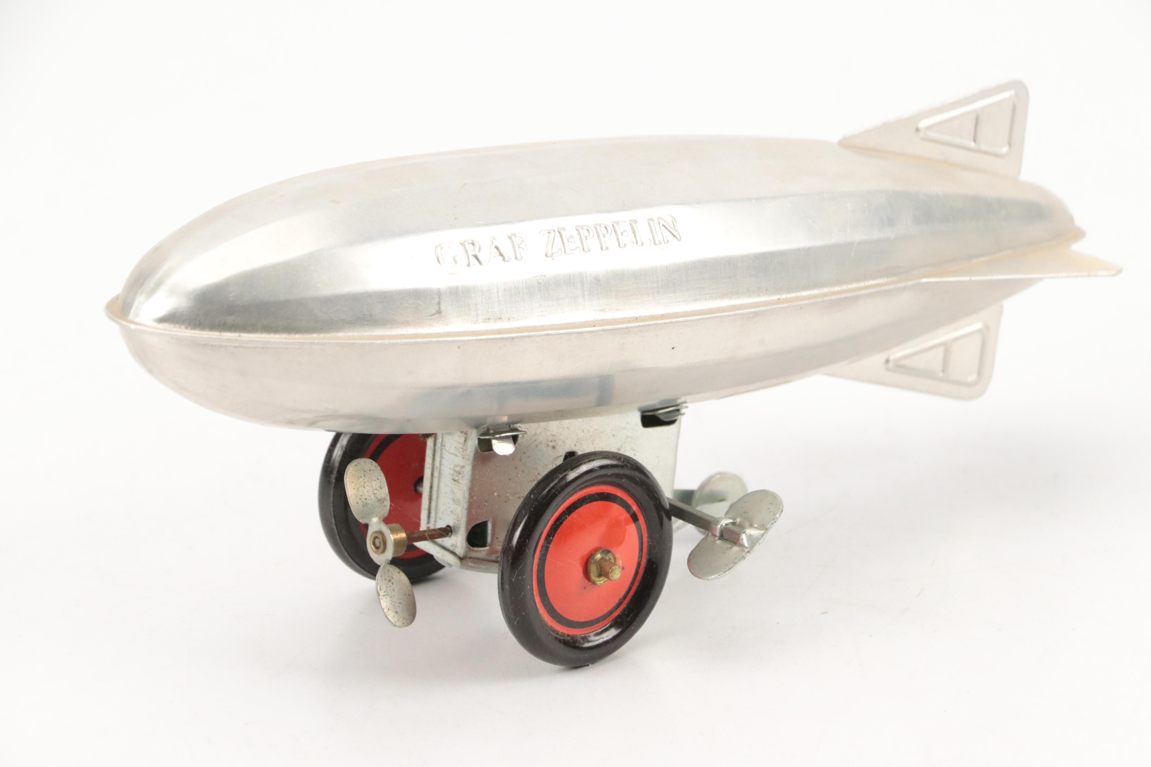 Schylling Tin Wind-Up Blimp Toy with Tin Litho Can Bank and Toy Weapons