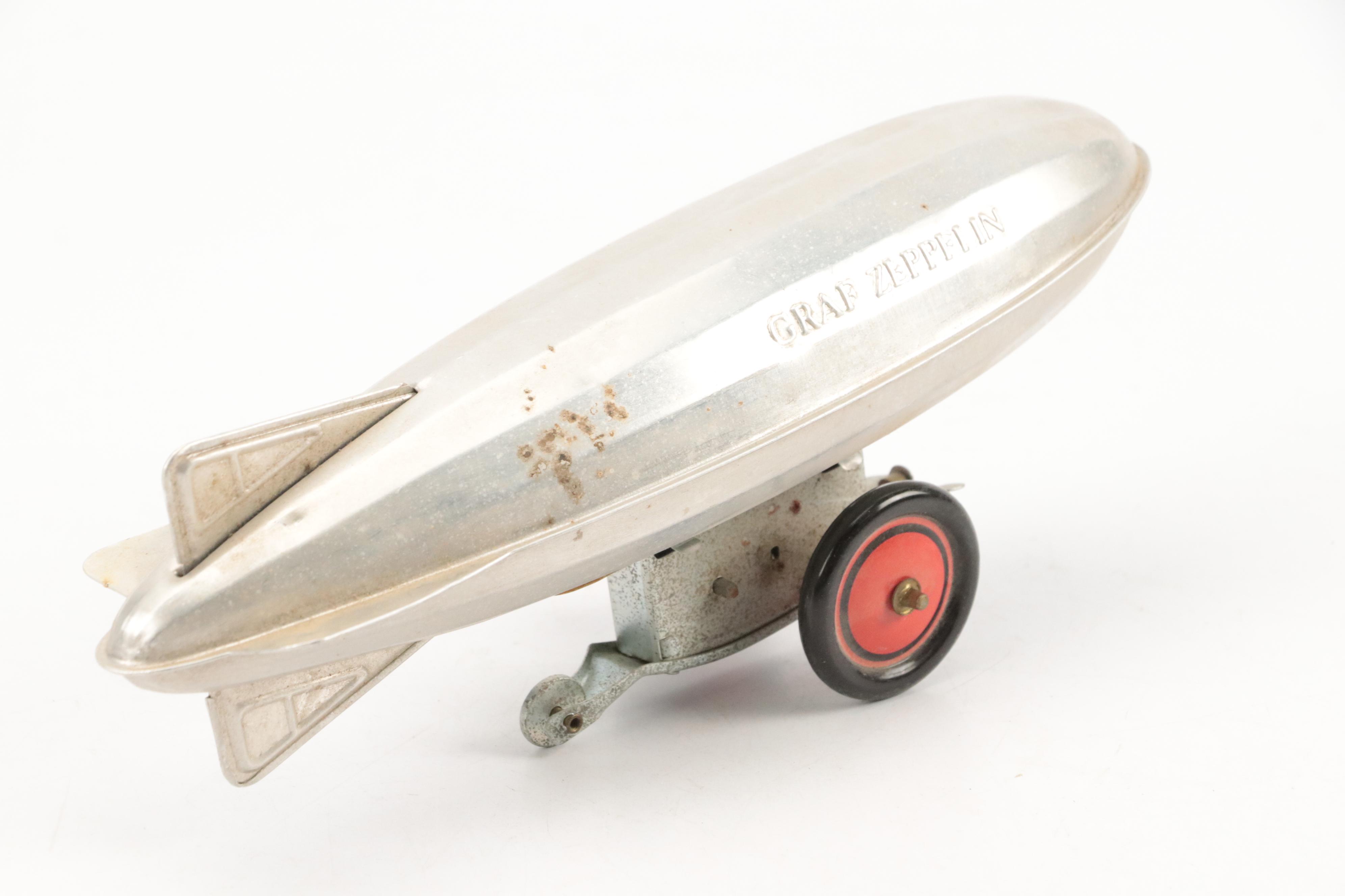 Schylling Tin Wind-Up Blimp Toy with Tin Litho Can Bank and Toy Weapons
