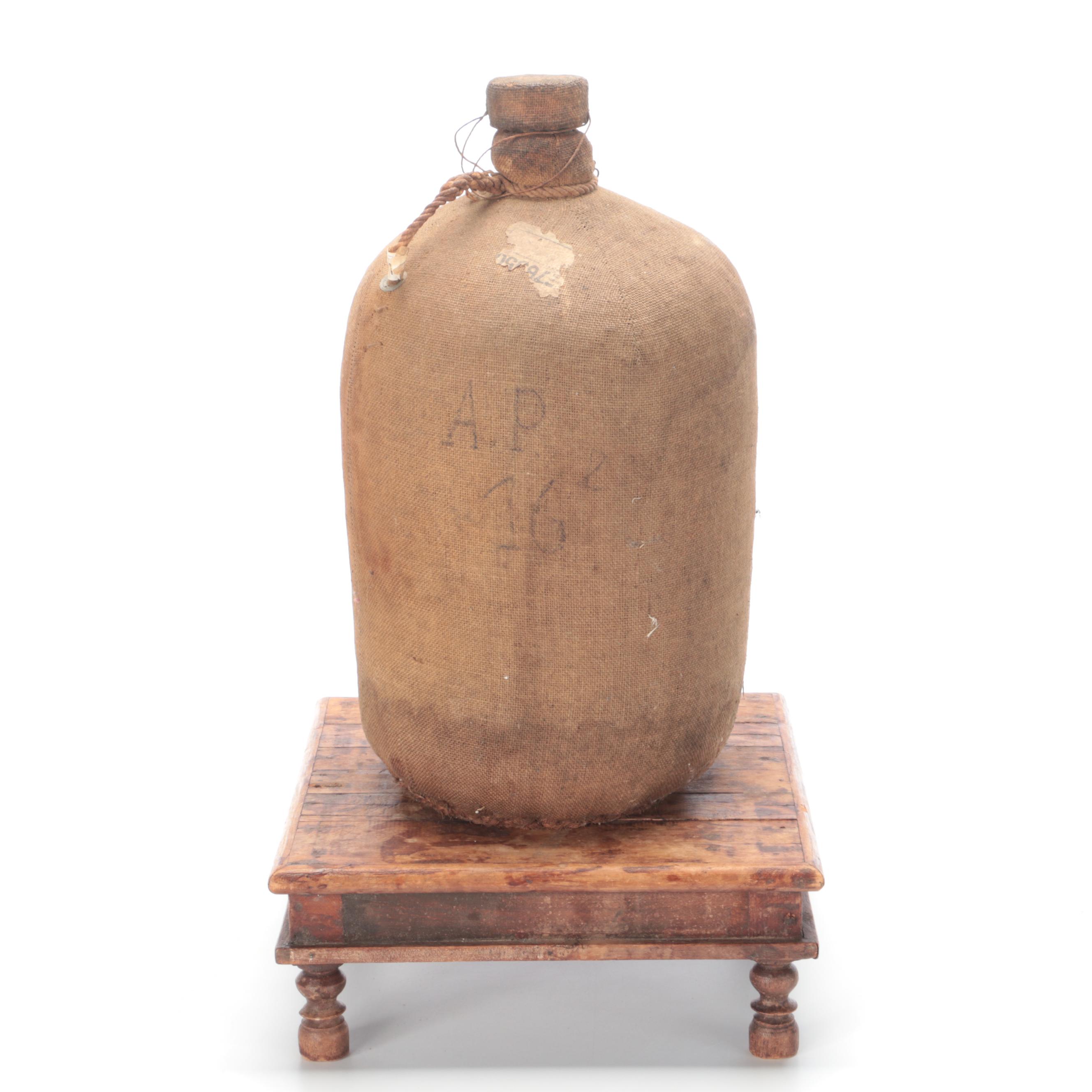 Burlap Covered Stoneware Water Jug with Wooden Platform