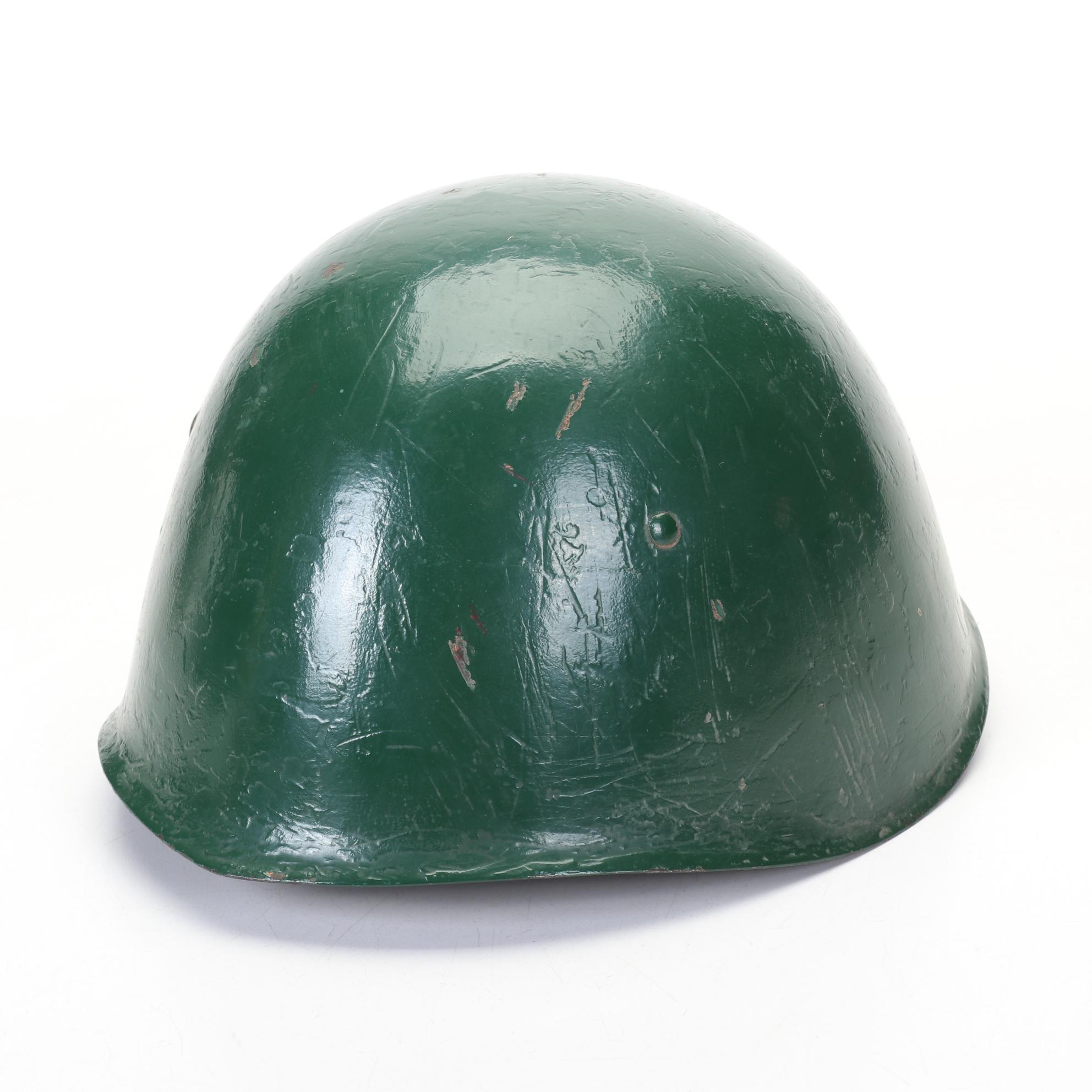 WWII Era Army and Civil Defense Helmets with Military Themed Comic Books