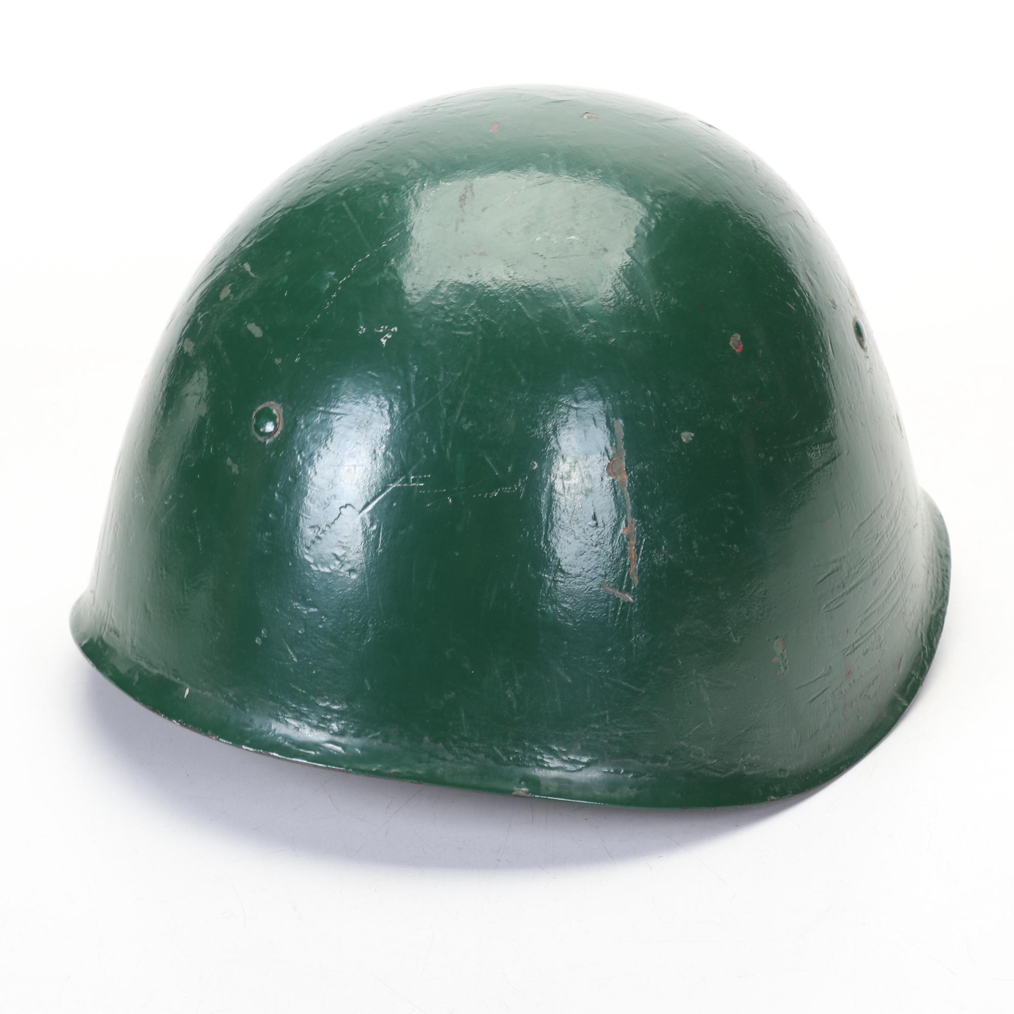 WWII Era Army and Civil Defense Helmets with Military Themed Comic Books