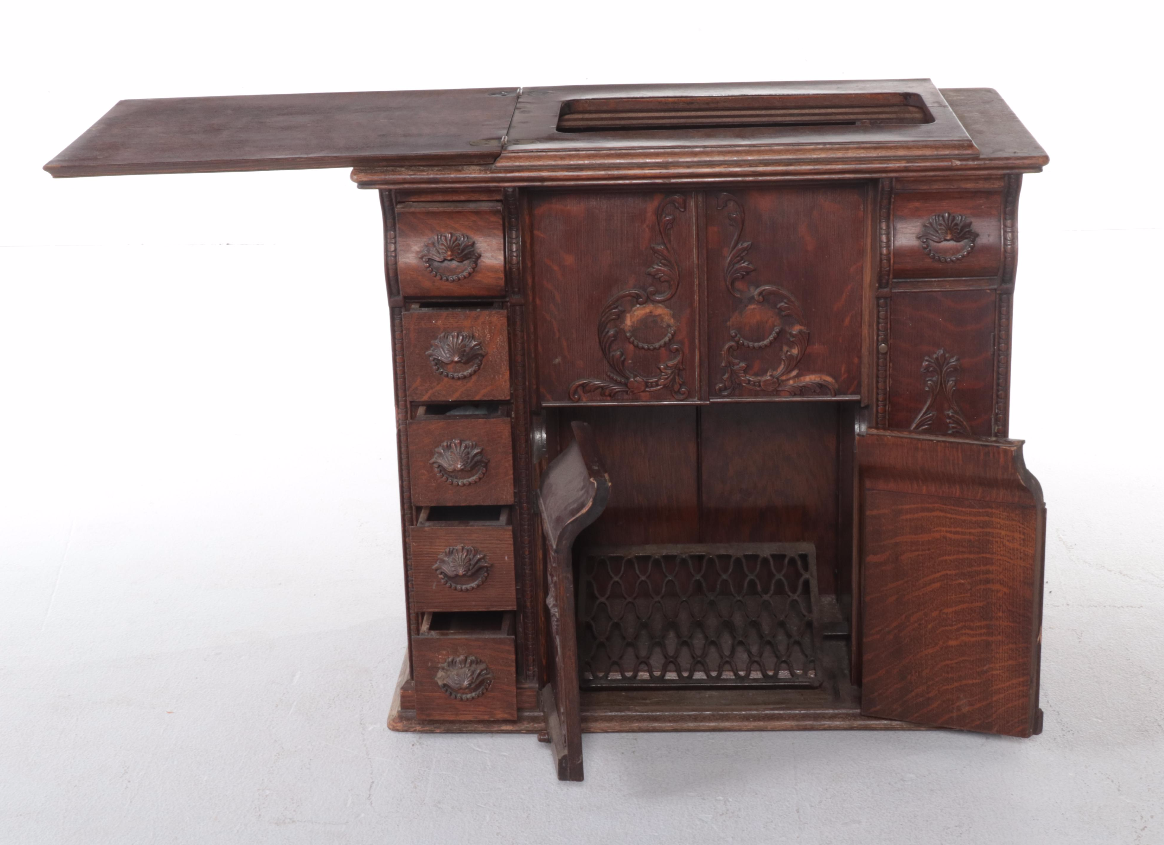 The Singer Mfg. Co Egyptian Revival Treadle-Base Sewing Machine in Oak Cabinet