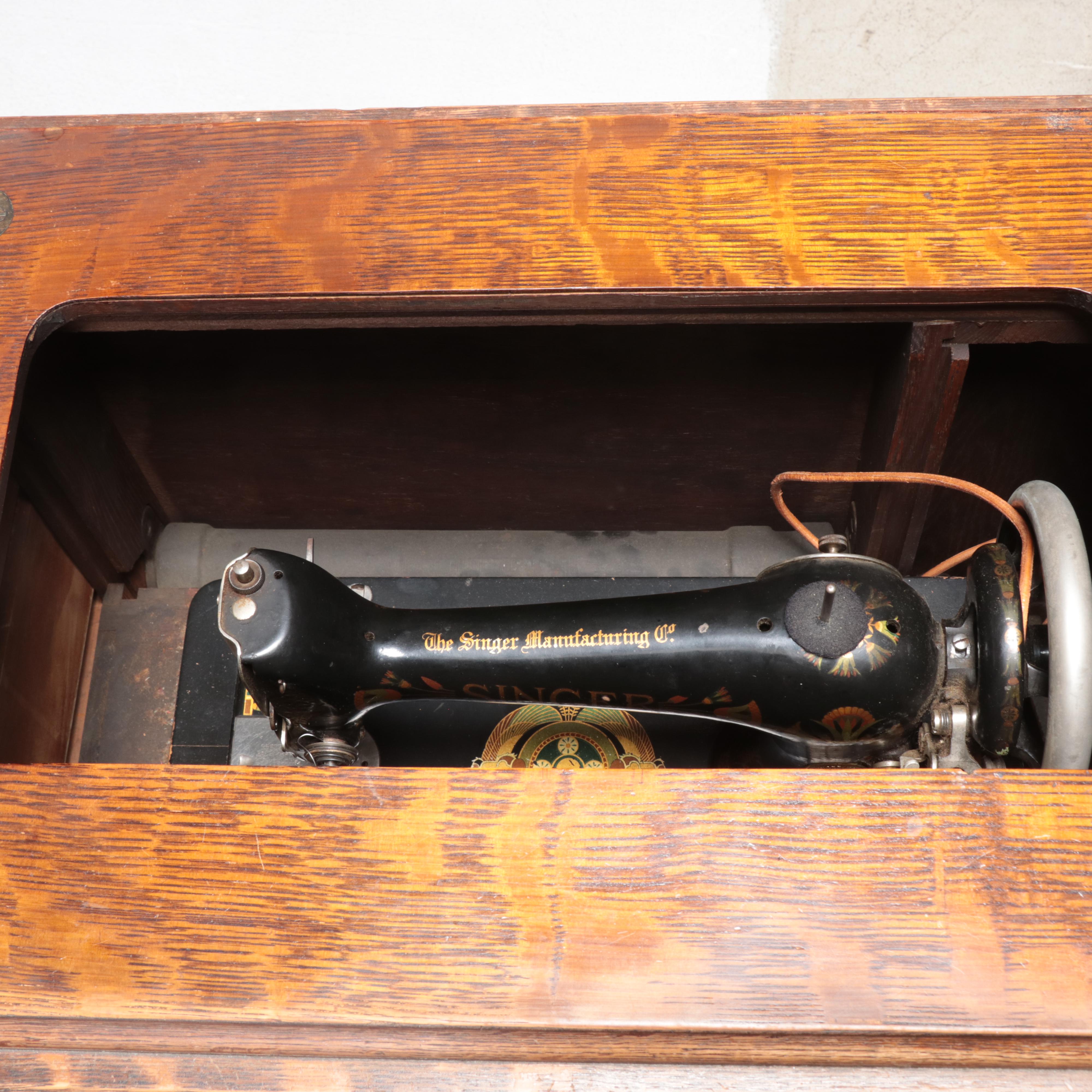 The Singer Mfg. Co Egyptian Revival Treadle-Base Sewing Machine in Oak Cabinet