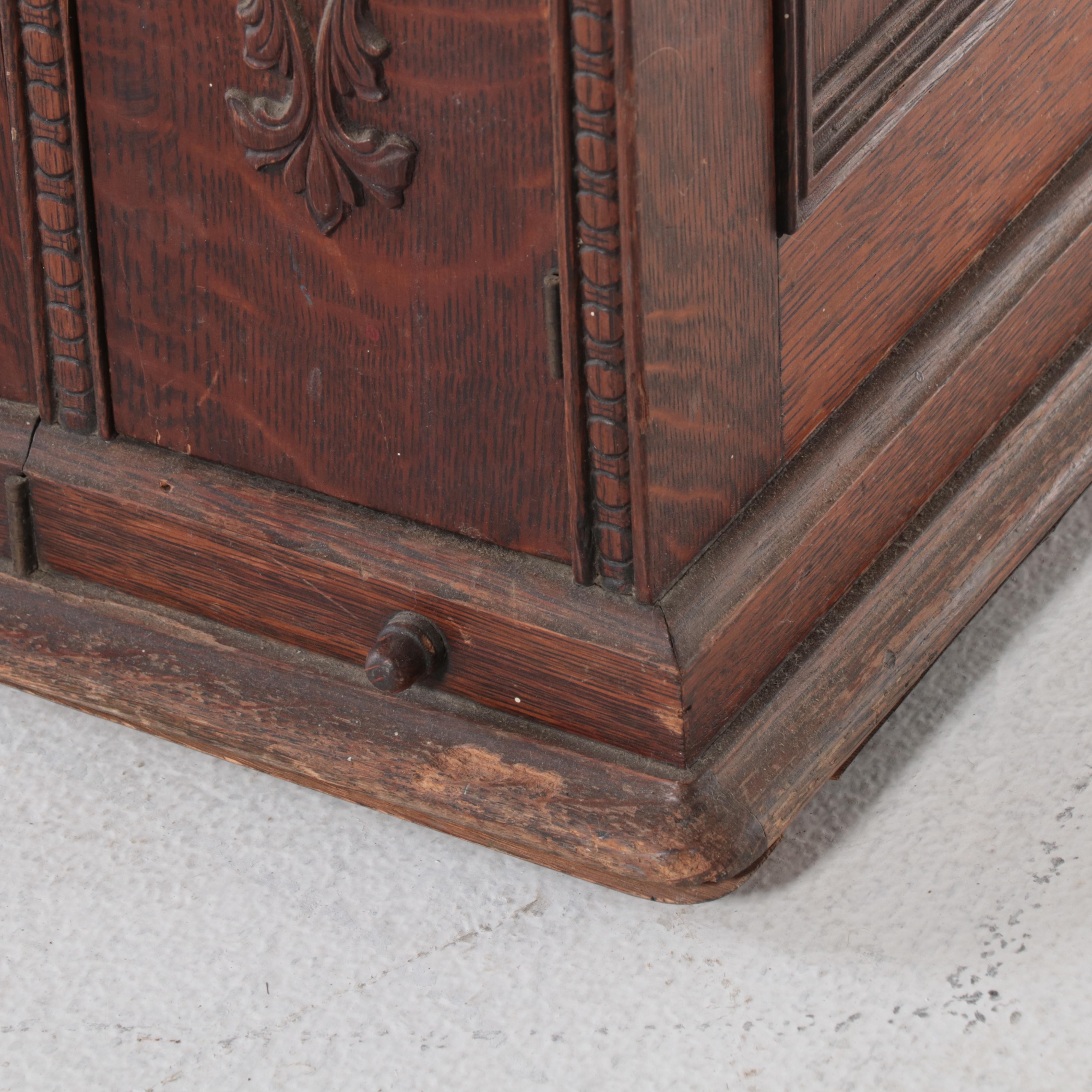 The Singer Mfg. Co Egyptian Revival Treadle-Base Sewing Machine in Oak Cabinet