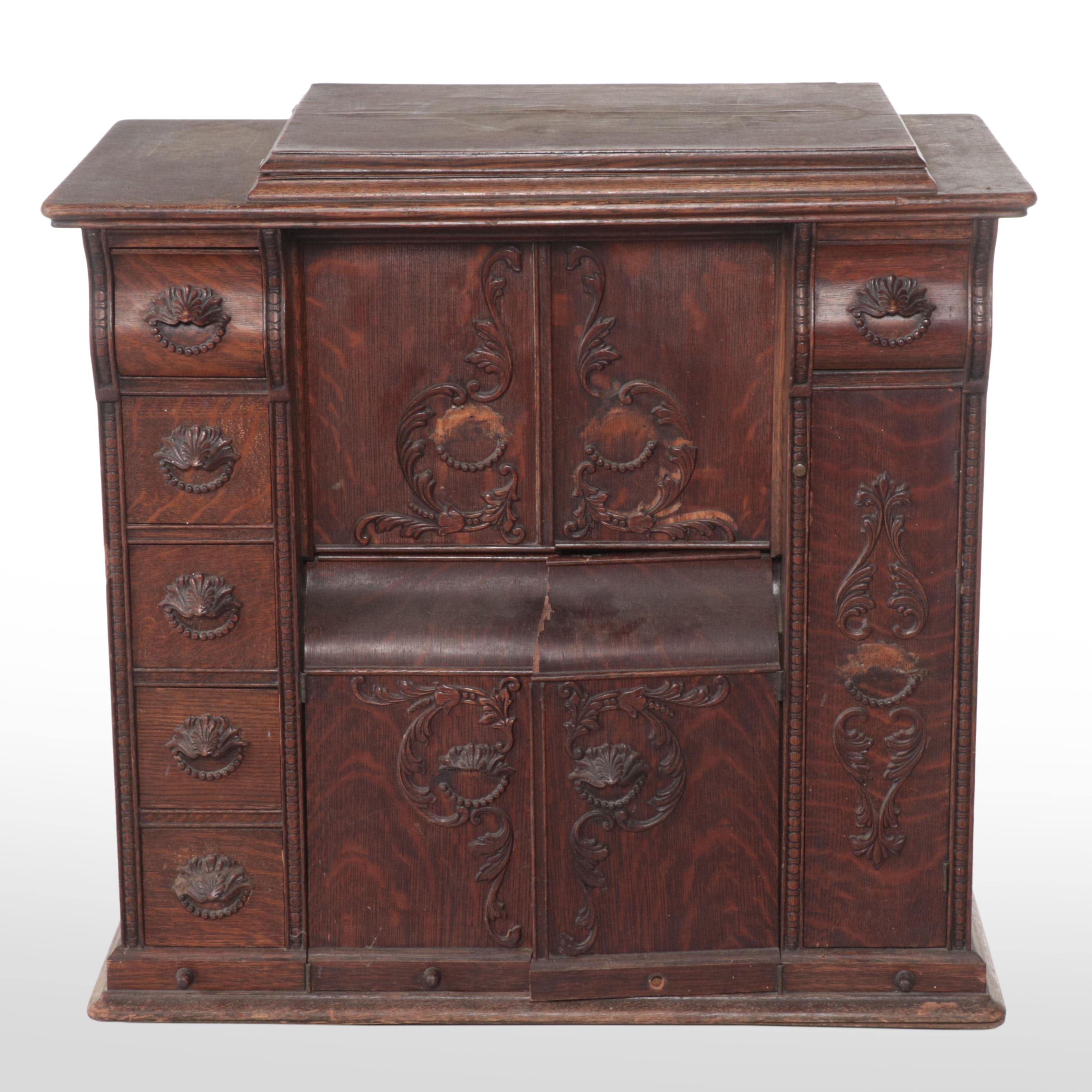 The Singer Mfg. Co Egyptian Revival Treadle-Base Sewing Machine in Oak Cabinet