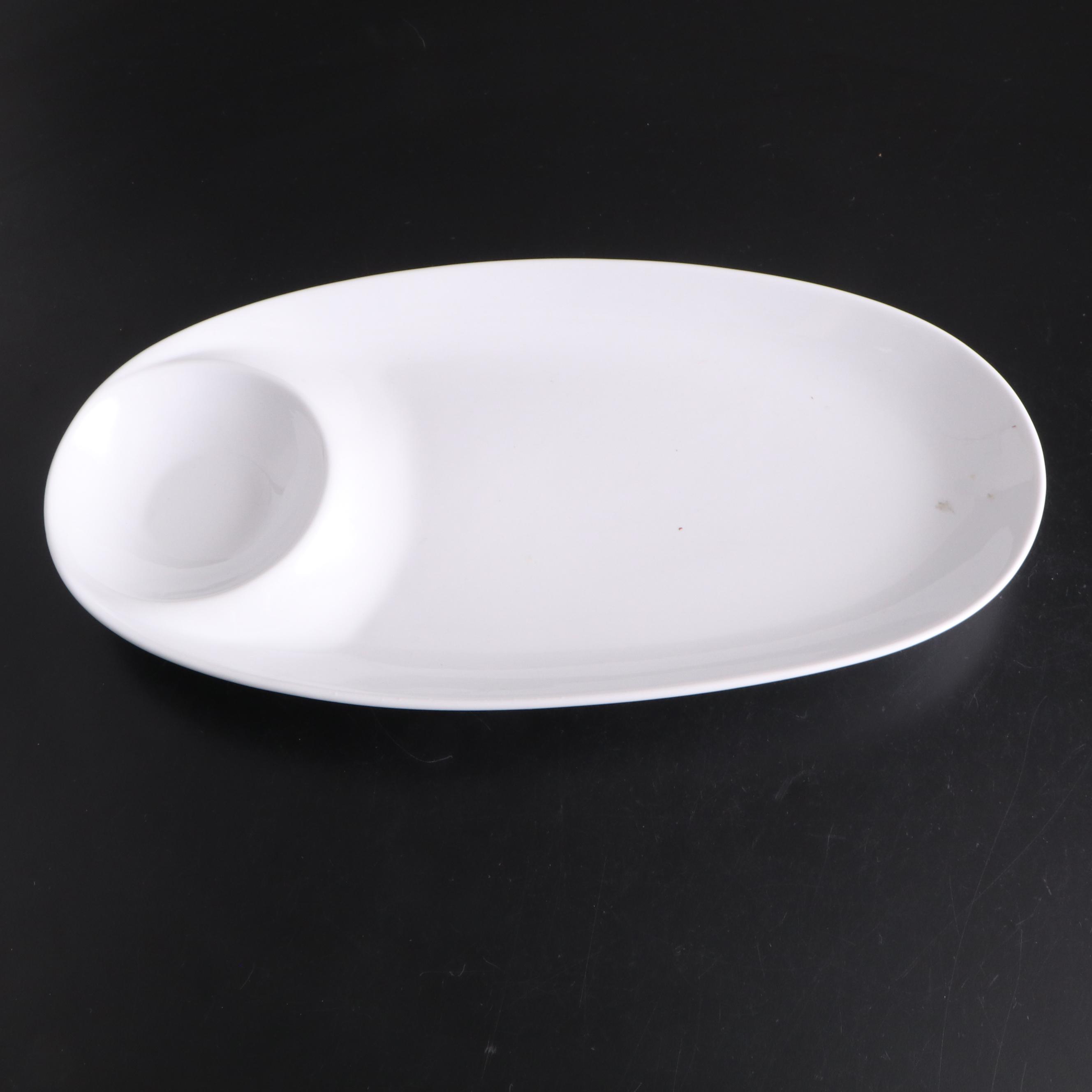 White Ceramic Serveware, Wood and Stone Cutting Board, and Metal Utensils