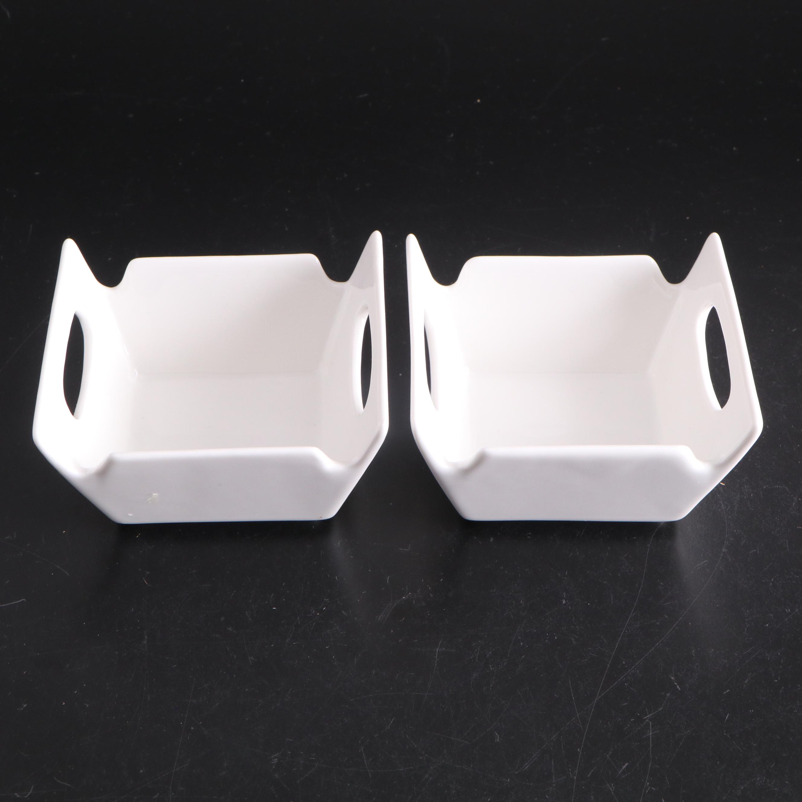 White Ceramic Serveware, Wood and Stone Cutting Board, and Metal Utensils