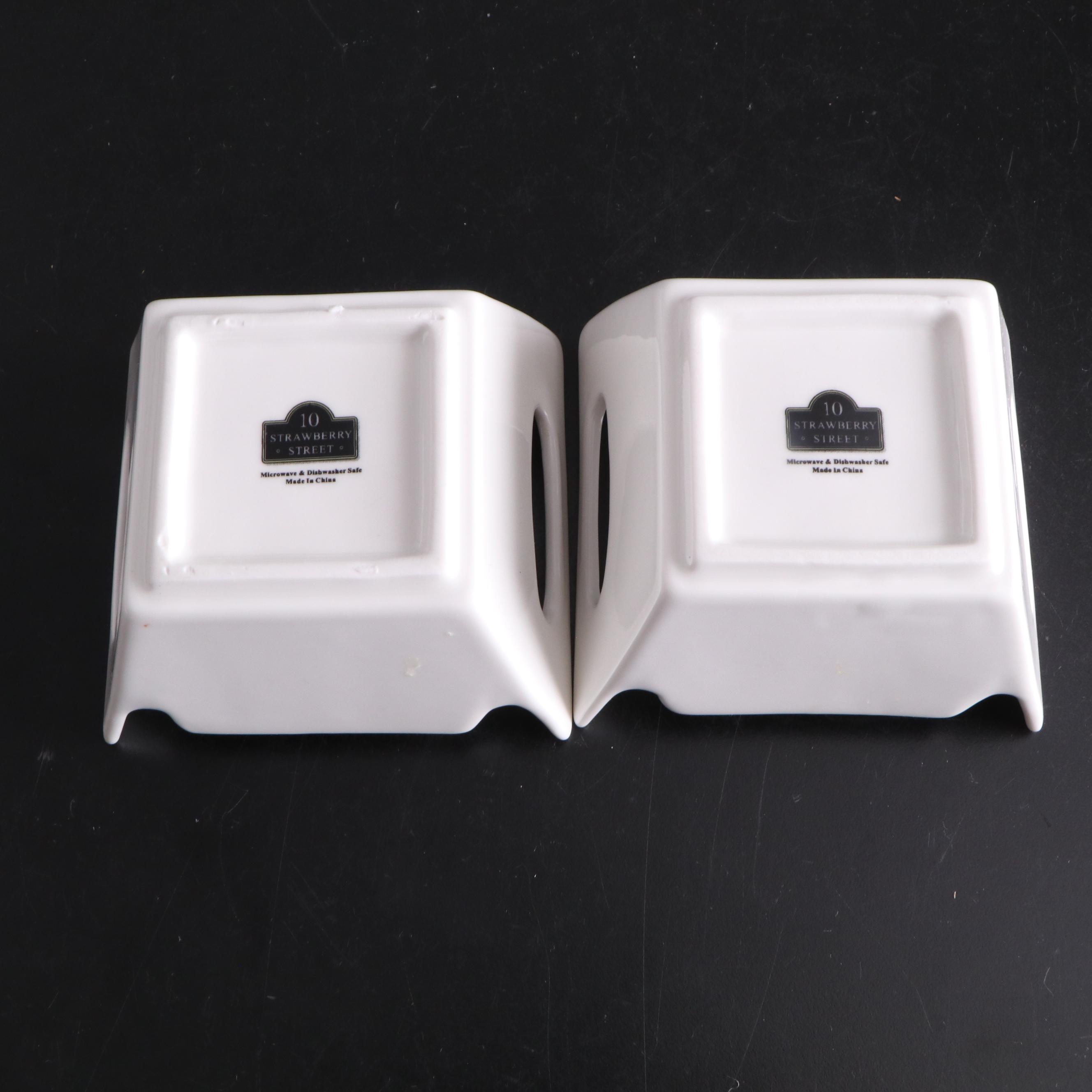 White Ceramic Serveware, Wood and Stone Cutting Board, and Metal Utensils