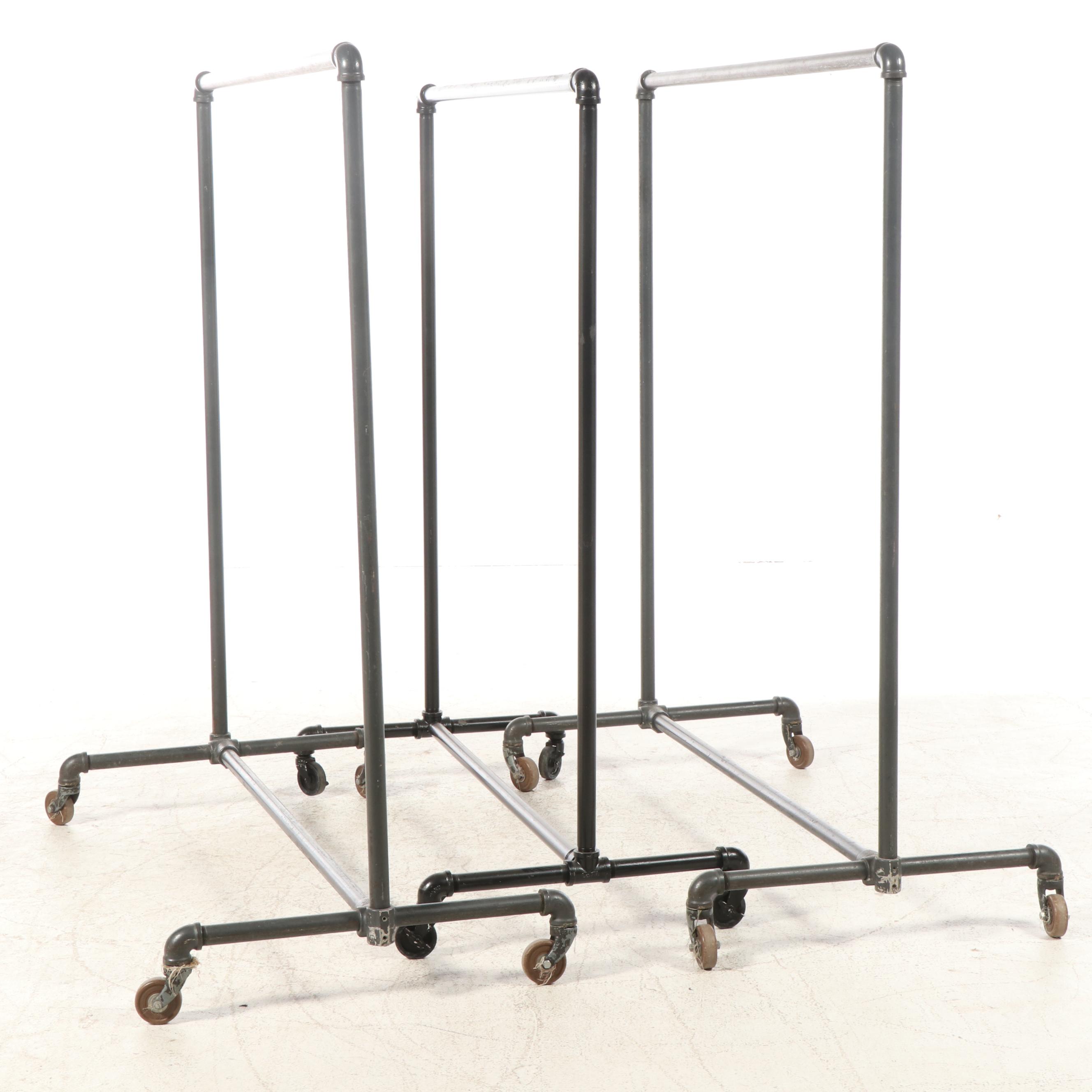 Three Black Iron Pipe Clothes Racks on Wheels