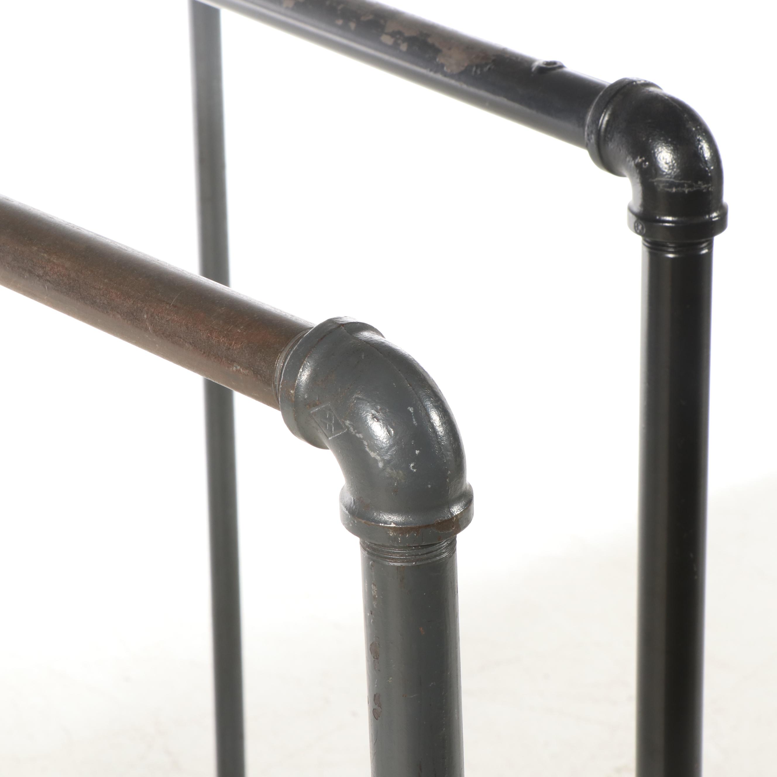 Three Black Iron Pipe Clothes Racks on Wheels