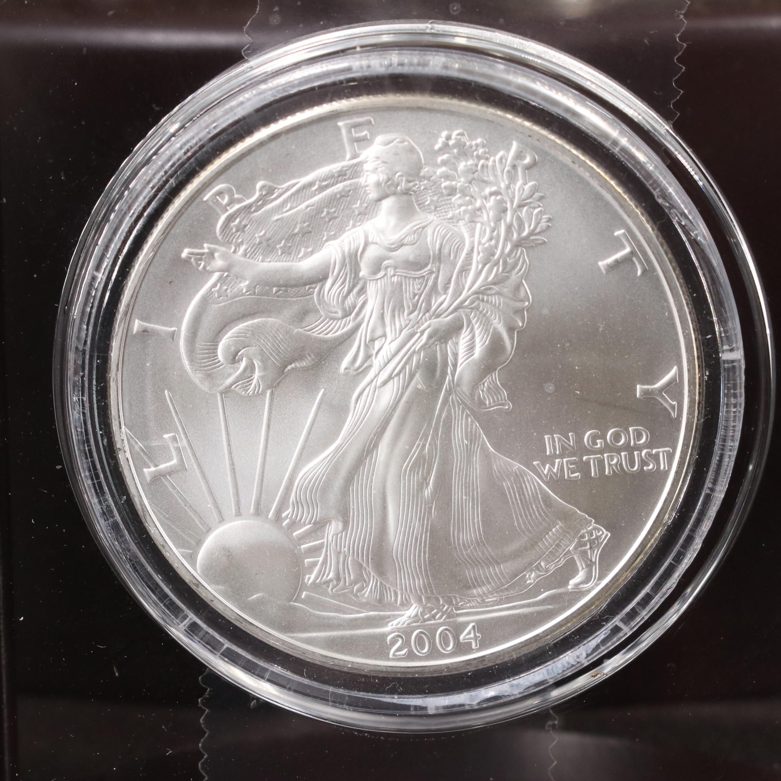 Resin Sculpture of a Bald Eagle With a Collection of American Silver Eagles