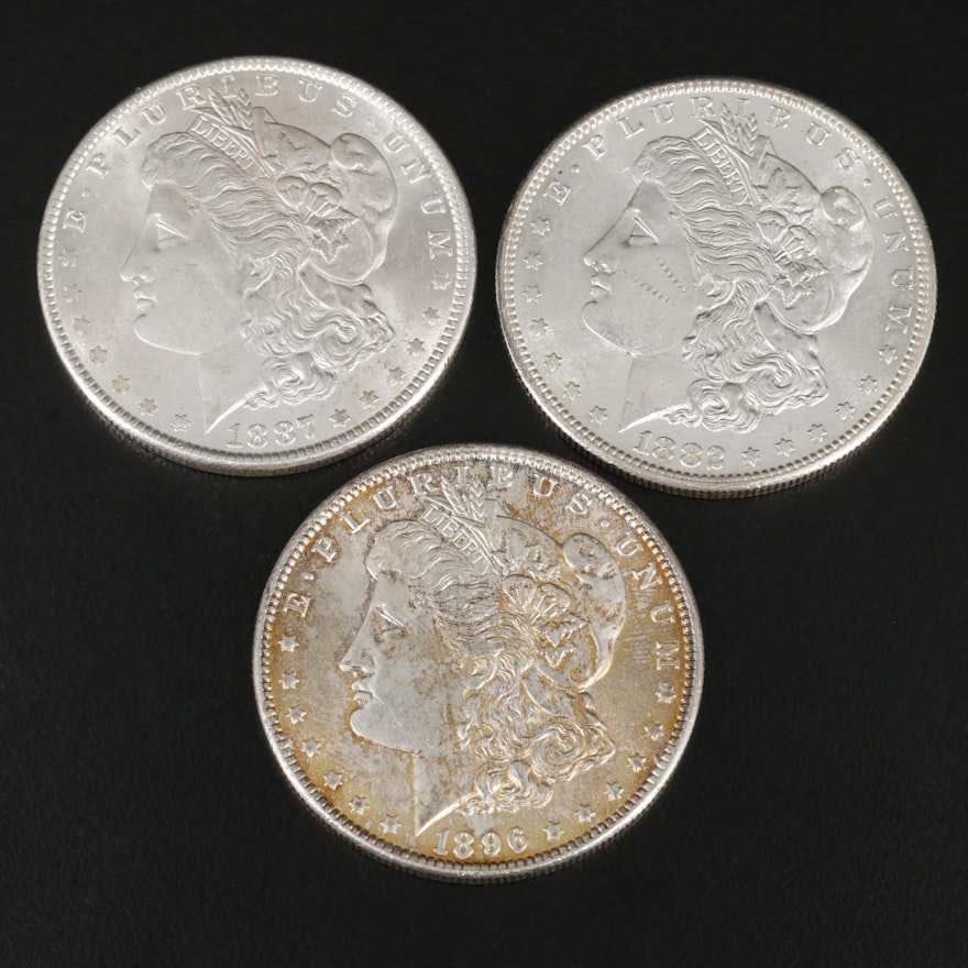 Three Morgan Silver Dollars Including an 1882-S