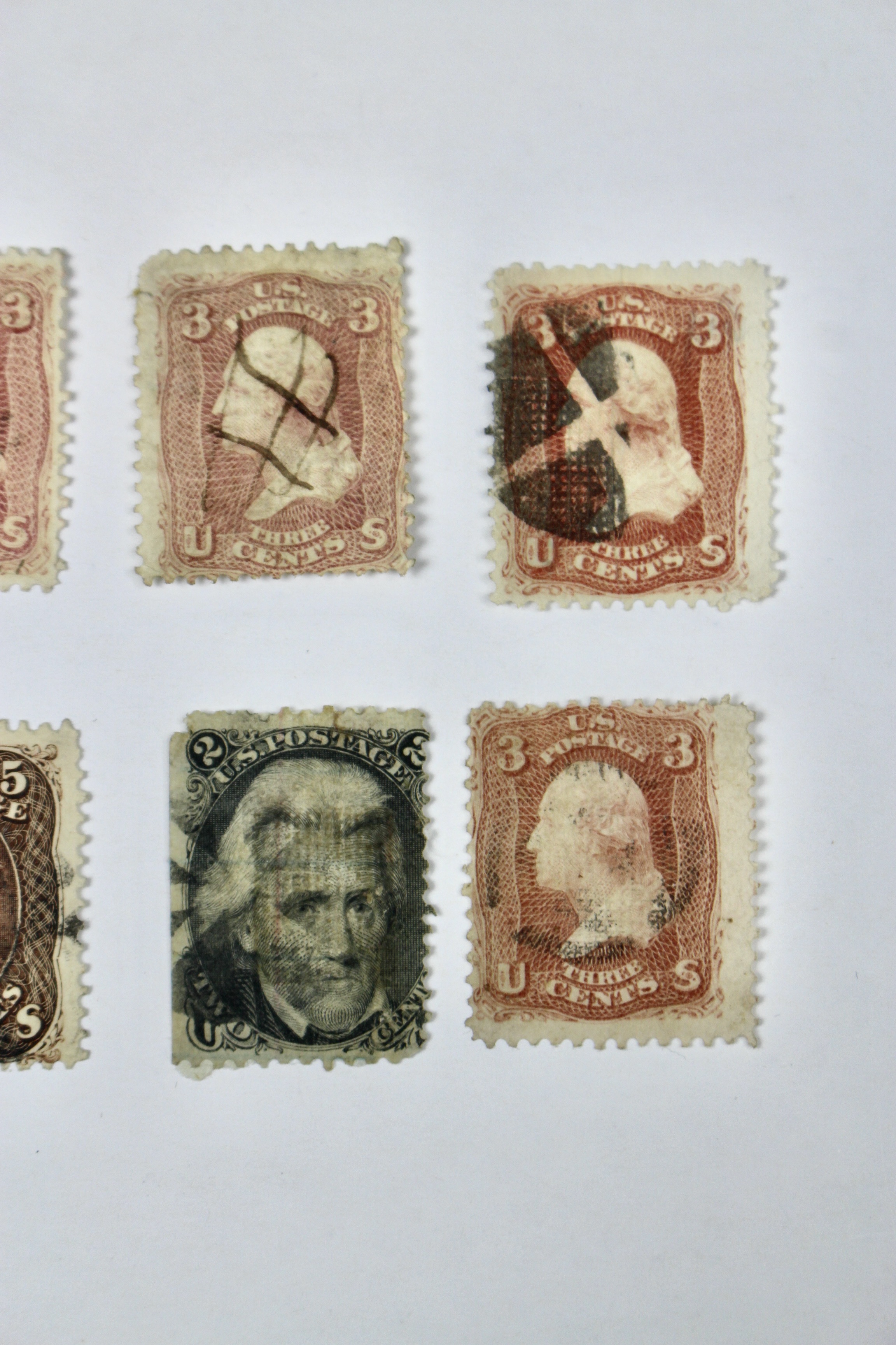 Twenty-Five Early U.S. Postage Stamps, Many with Grills