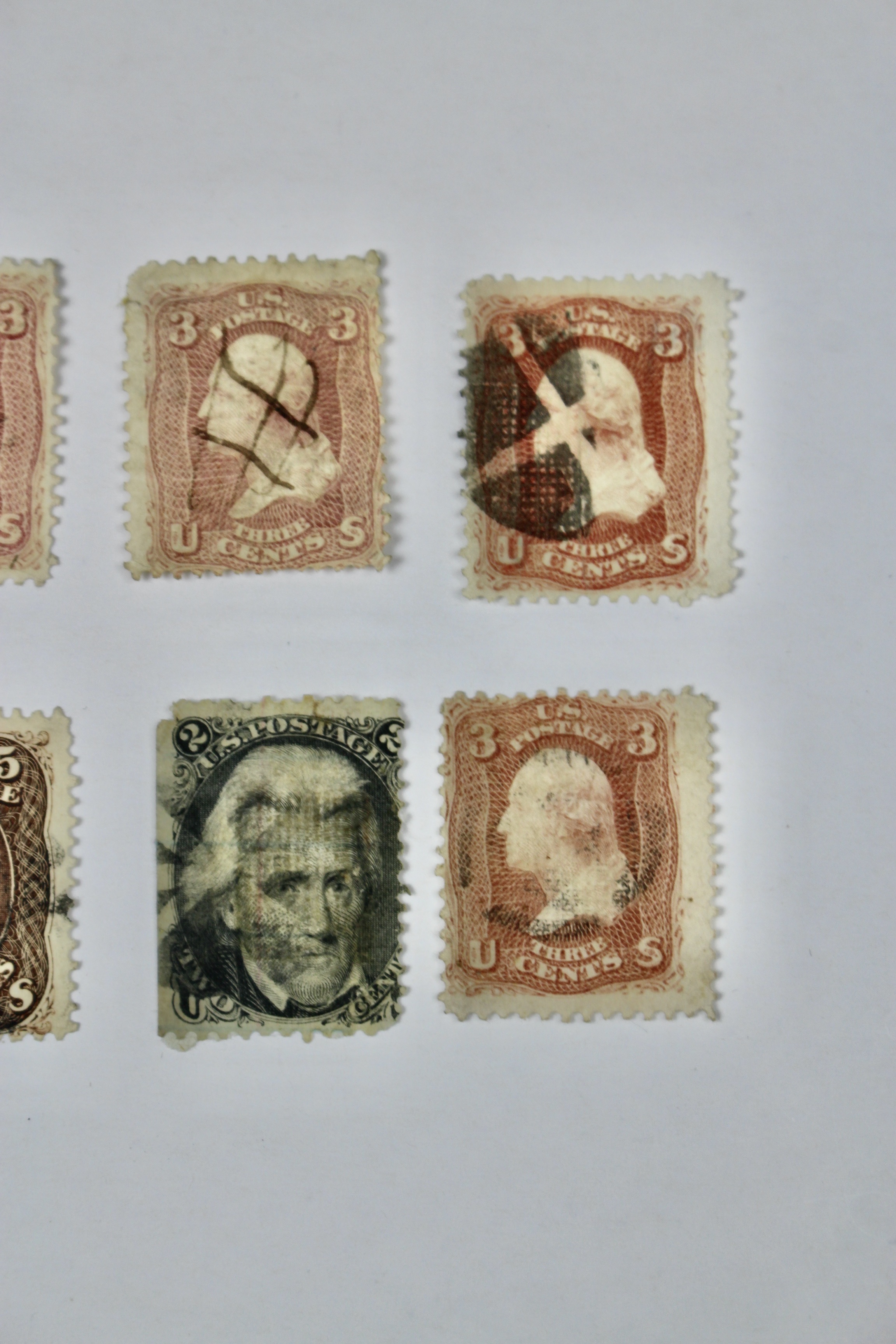 Twenty-Five Early U.S. Postage Stamps, Many with Grills