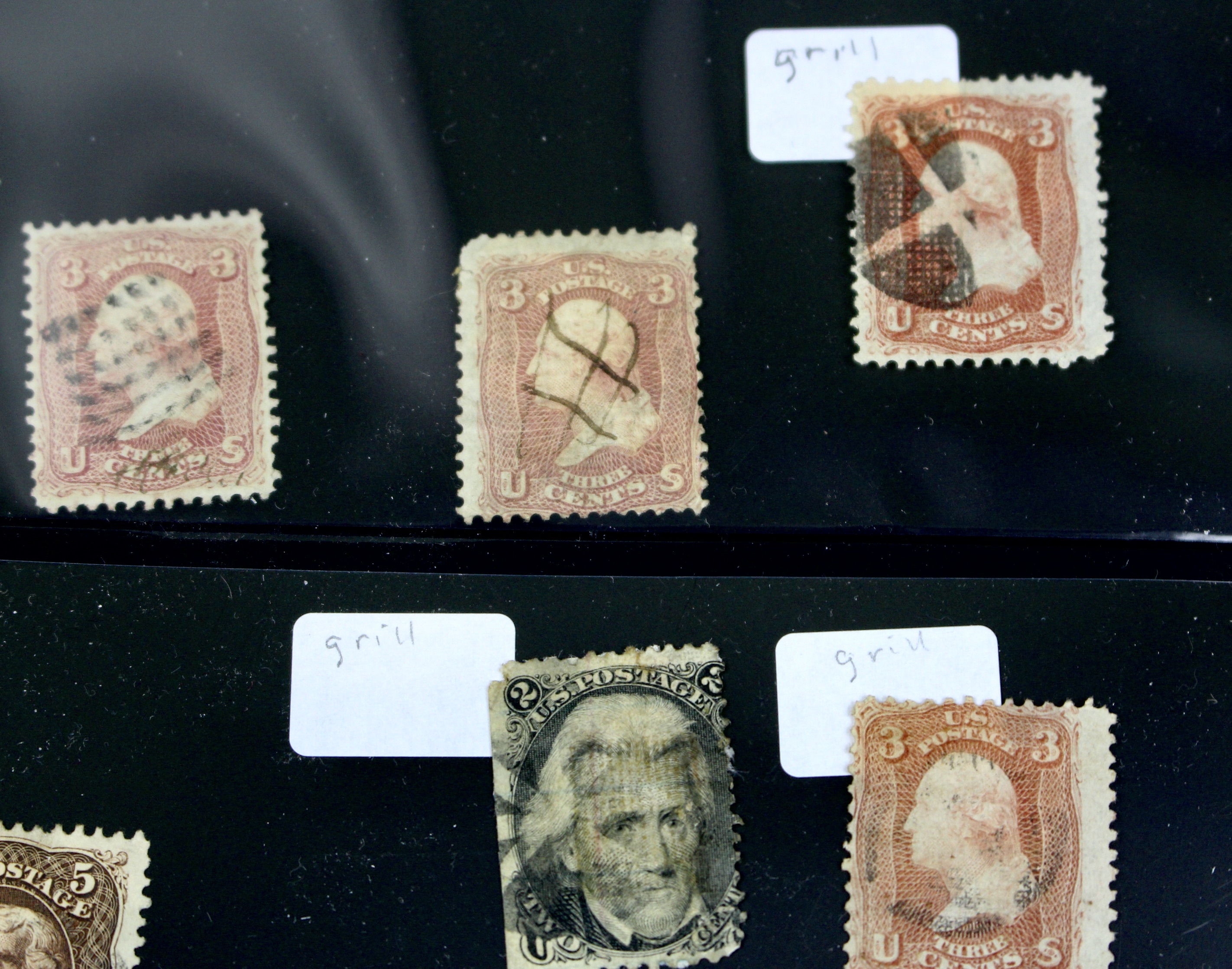 Twenty-Five Early U.S. Postage Stamps, Many with Grills